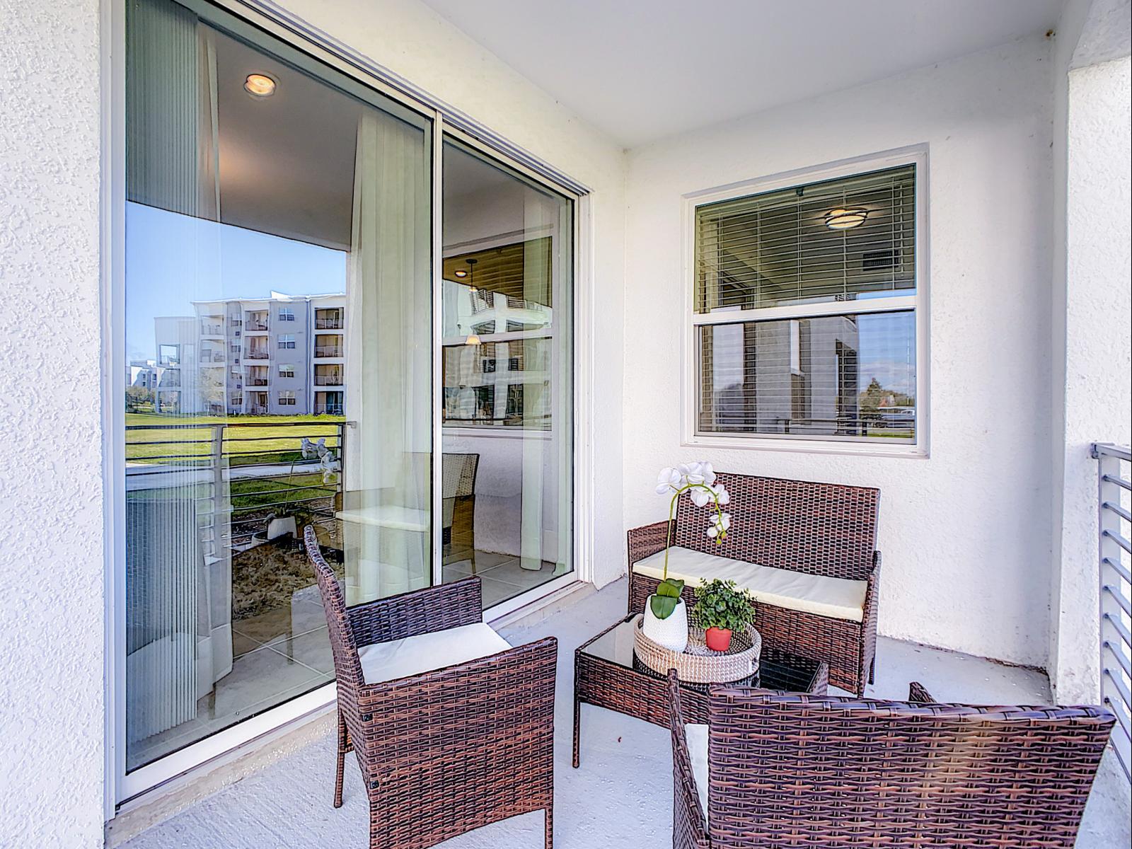 Charming balcony setup with cozy wicker seating, perfect for morning coffee or evening chats - Enjoy the fresh air and serene views, adding a refreshing outdoor escape to your stay - Stylish balcony nook feels like an extension of the living space