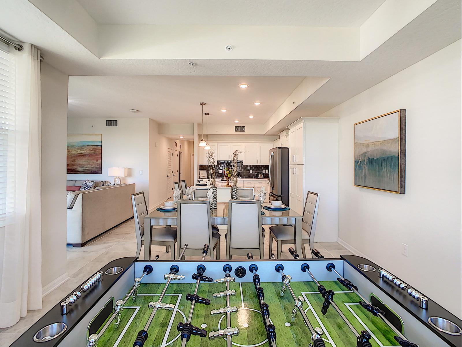 Dining and Gaming Chic: Imbibe in the elegance of our condo's dining area, where sophisticated chairs and a game table set the stage for stylish meals and recreational moments