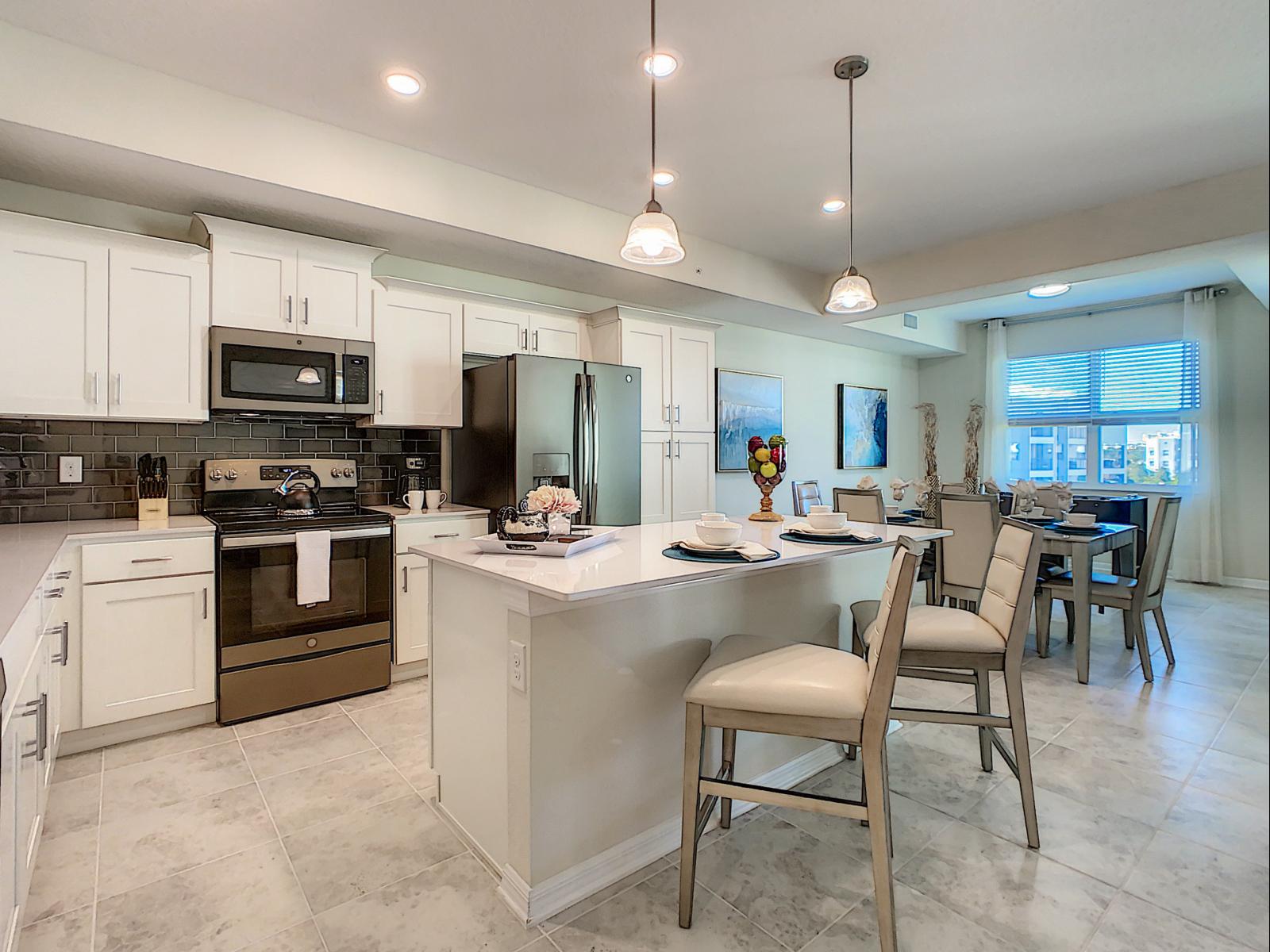 Sleek and Functional: Experience the best of both worlds in our Airbnb condo – a fully furnished, open-concept kitchen that blends style and practicality effortlessly