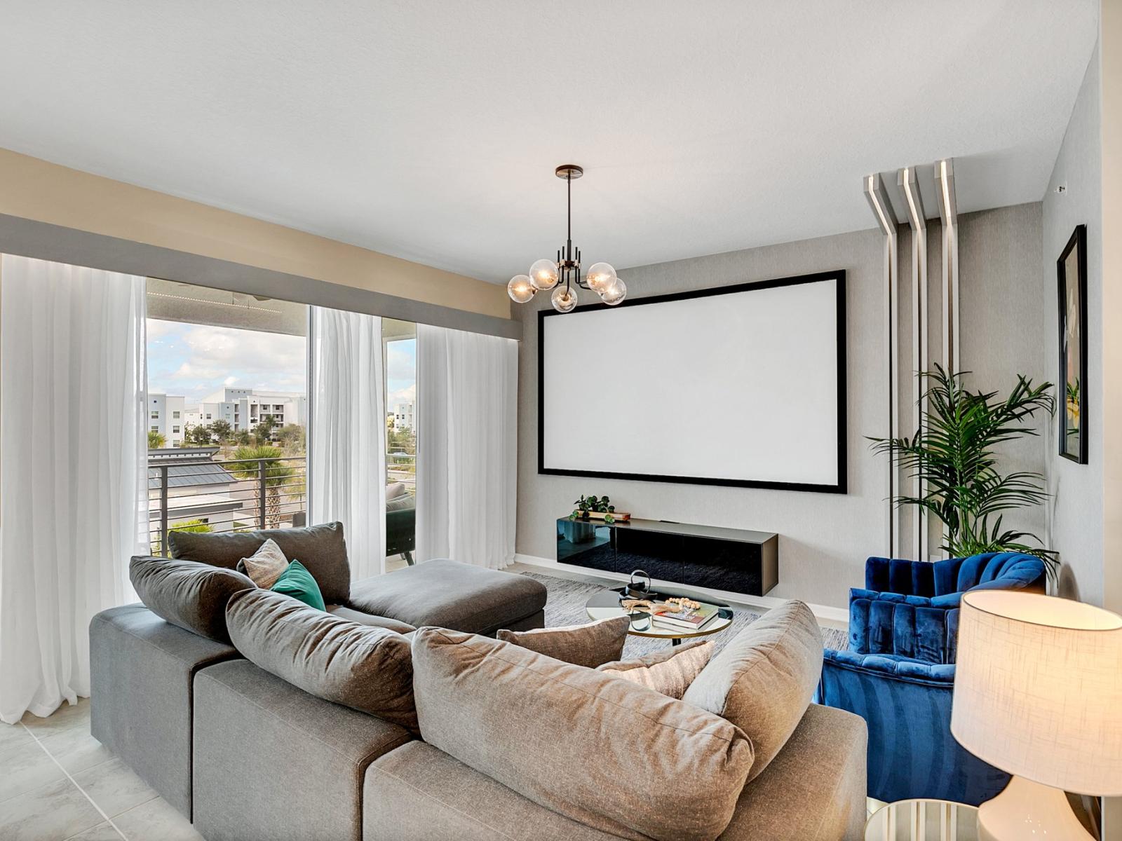 Stylish living area of the condo in Kissimmee Florida - Unwind in the living area with movie projector - Stylish furniture arrangement providing comfort and a cohesive look - Cozy seating for relaxation