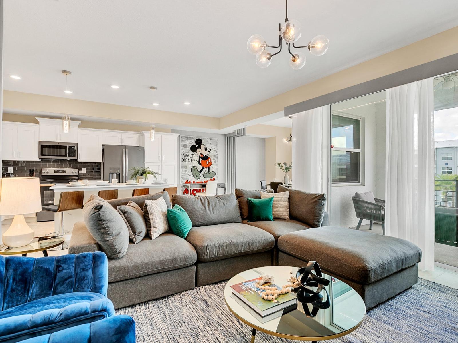 Luxe living area of the condo in Kissimmee Florida - Harmonious color scheme with pops of accent colors for visual interest - Cozy seating area conducive to relaxation and socializing - Easy access to balcony with se