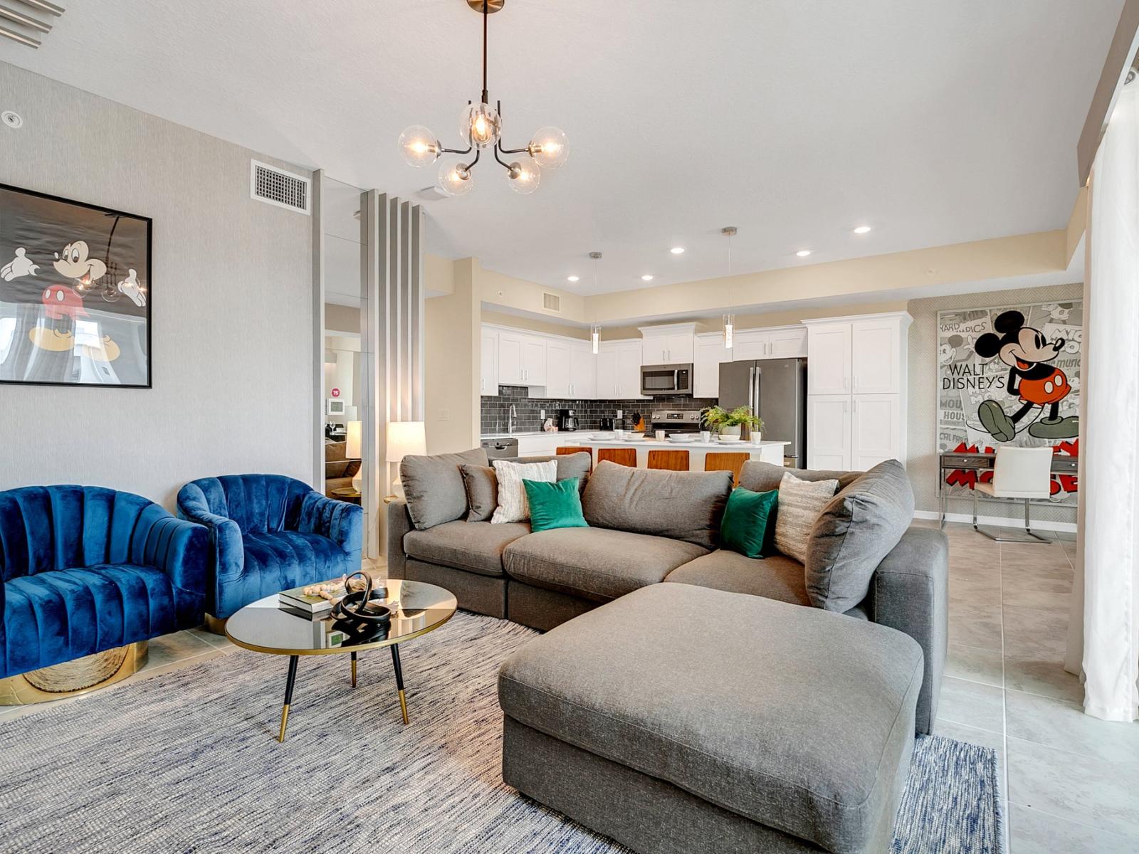 Charming living area of the condo in Kissimmee Florida - Transforms with a movie projector, offering cinematic bliss and cozy gatherings - Thoughtful mix of textures, from plush rugs to tasteful throw pillows - Comfy sofas and inviting ambiance