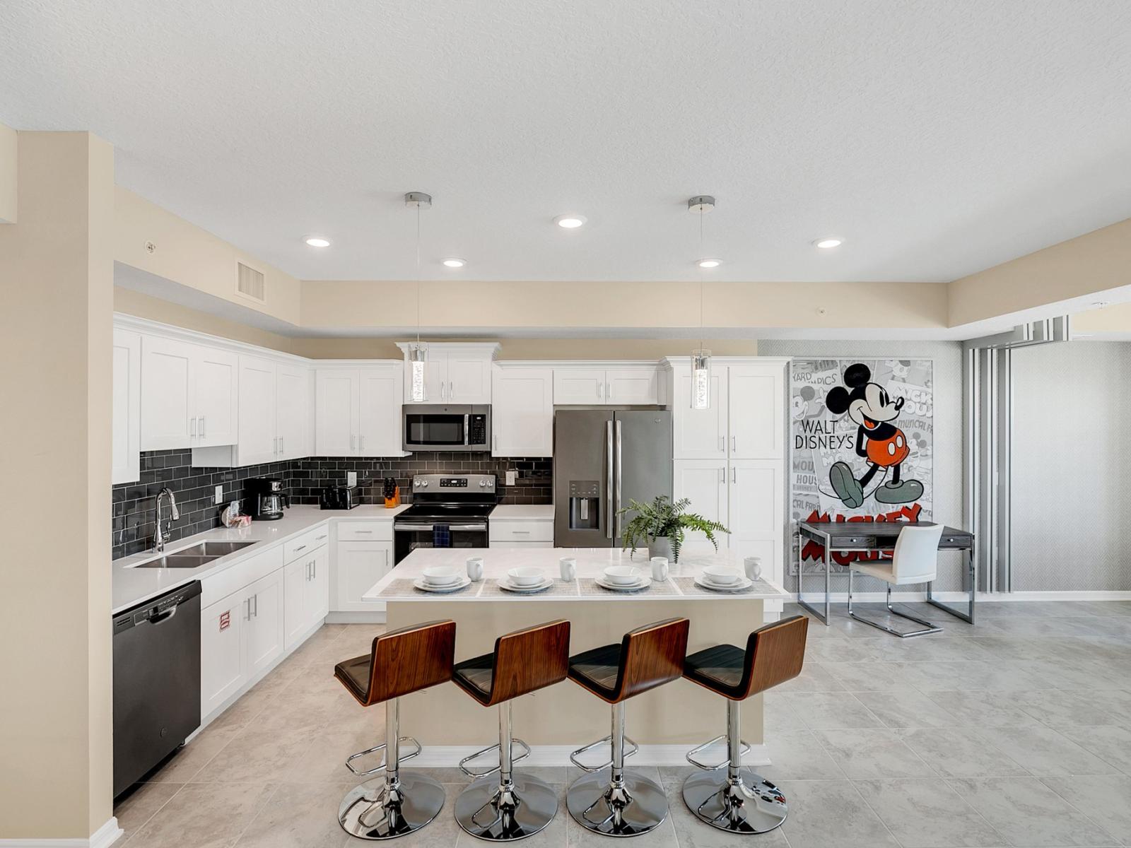 Well-Designed Kitchen of the condo in Kissimmee Florida - Integrated appliances for a seamless and stylish appearance - Thoughtful placement of kitchen essentials for easy access - Breakfast bar and high chairs