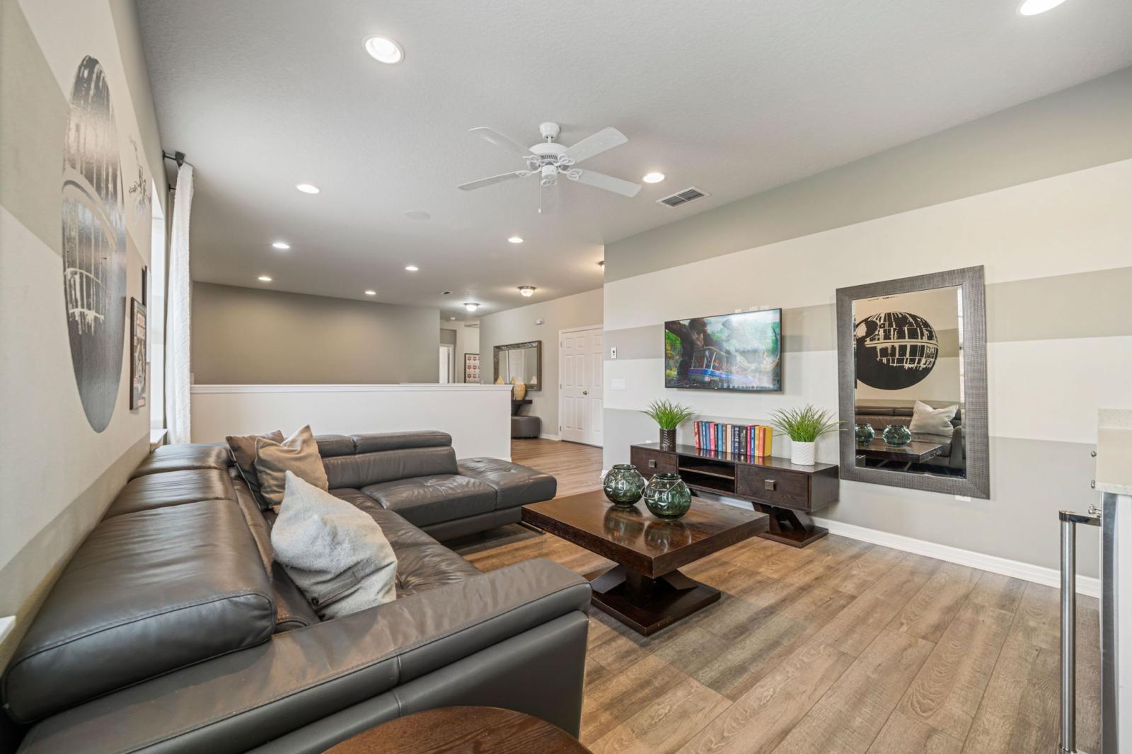 Loft area with a large Smart Tv and seating area