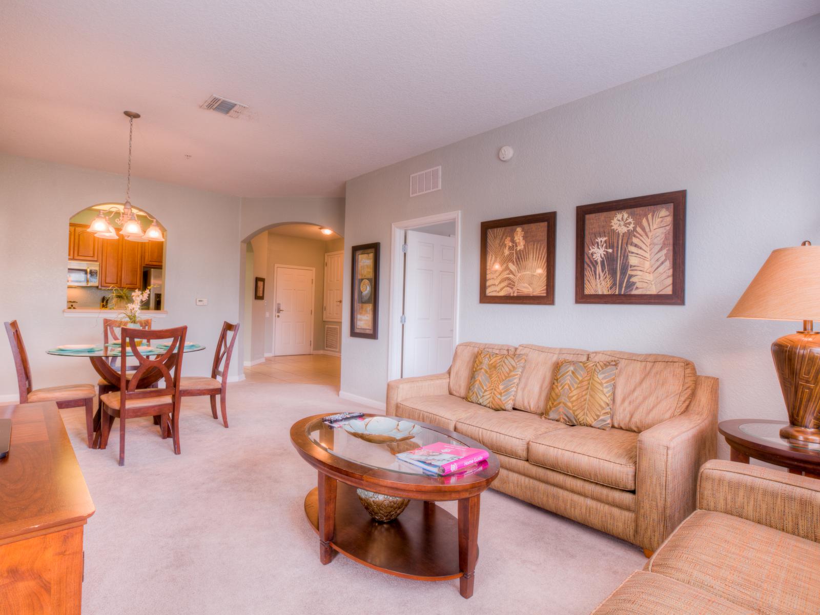 The living and dining room at Vista Cay Resort blend comfort and elegance, providing guests with a welcoming space to relax, dine, and create cherished memories.