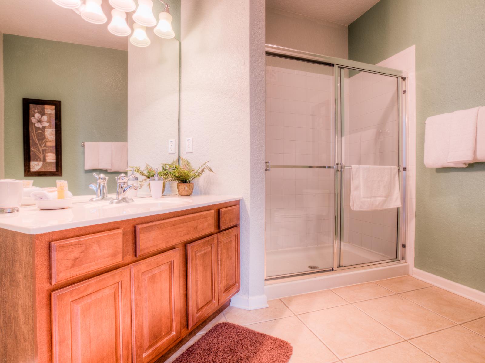 The bathroom at Vista Cay Resort includes a vanity area, offering  a stylish and well-lit space for grooming and preparing for the day, adding a touch of luxury.