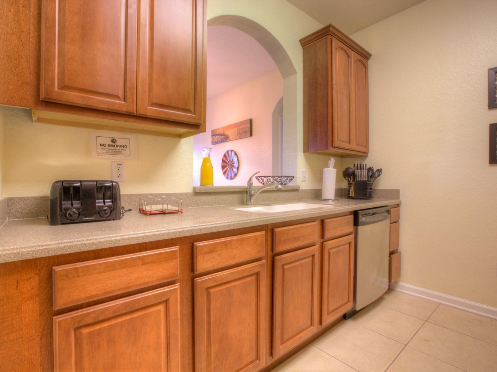 Feasting has never been so comfortable with this lovely kitchen with  gorgeous countertops, pristine cabinetry, and deluxe stainless-steel appliances.