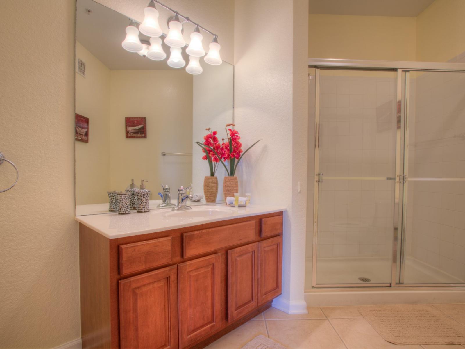 Enjoy a good hot bath in this clean and spotless bathroom with walk-in shower.