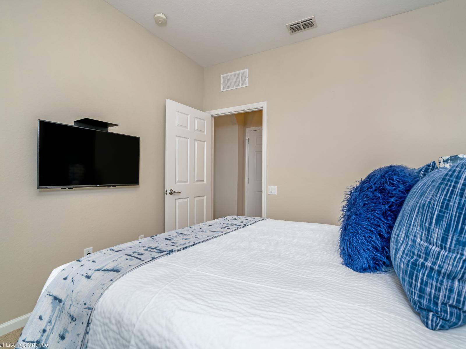 The second bedroom features a comfortable queen-size bed, offering a cozy retreat for guests. With its inviting ambiance and plush bedding, this bedroom provides a serene space for relaxation after a day of exploration.