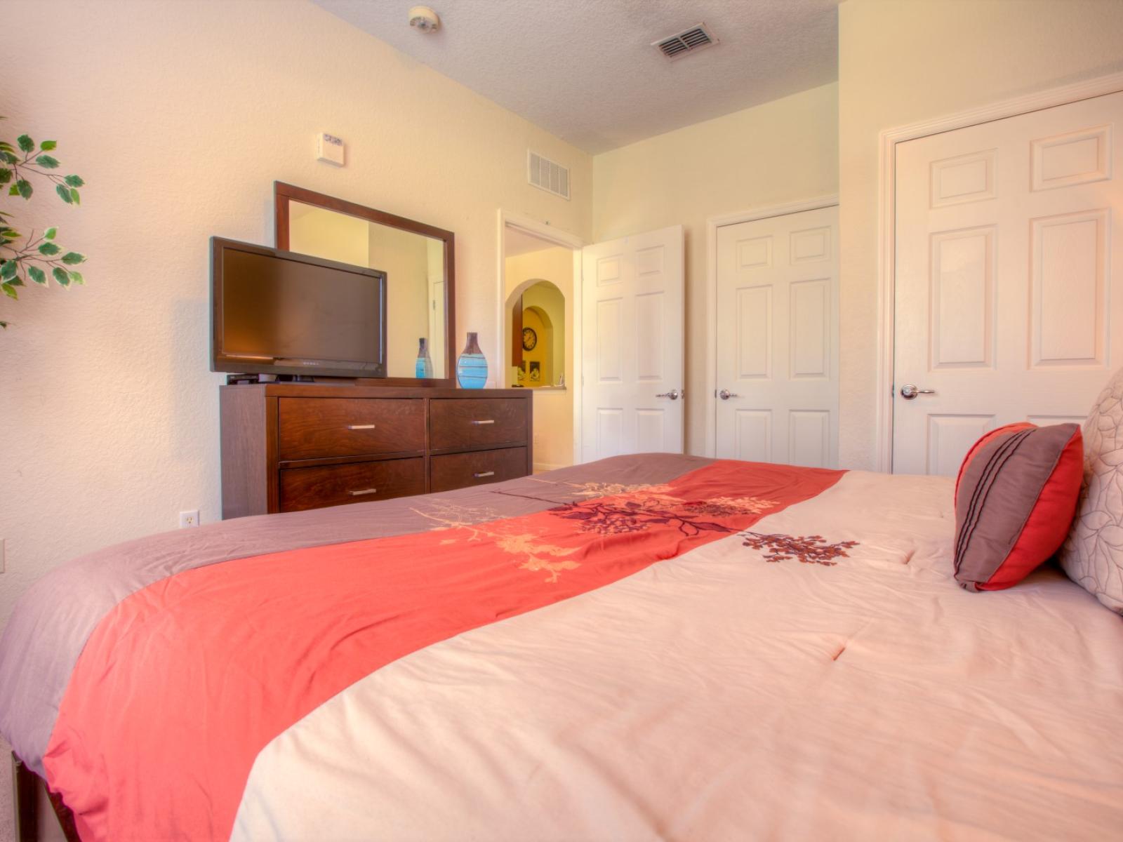 Relax in comfort in this spacious master bedroom, complete with a TV for entertainment and an ensuite bathroom for added convenience and privacy.