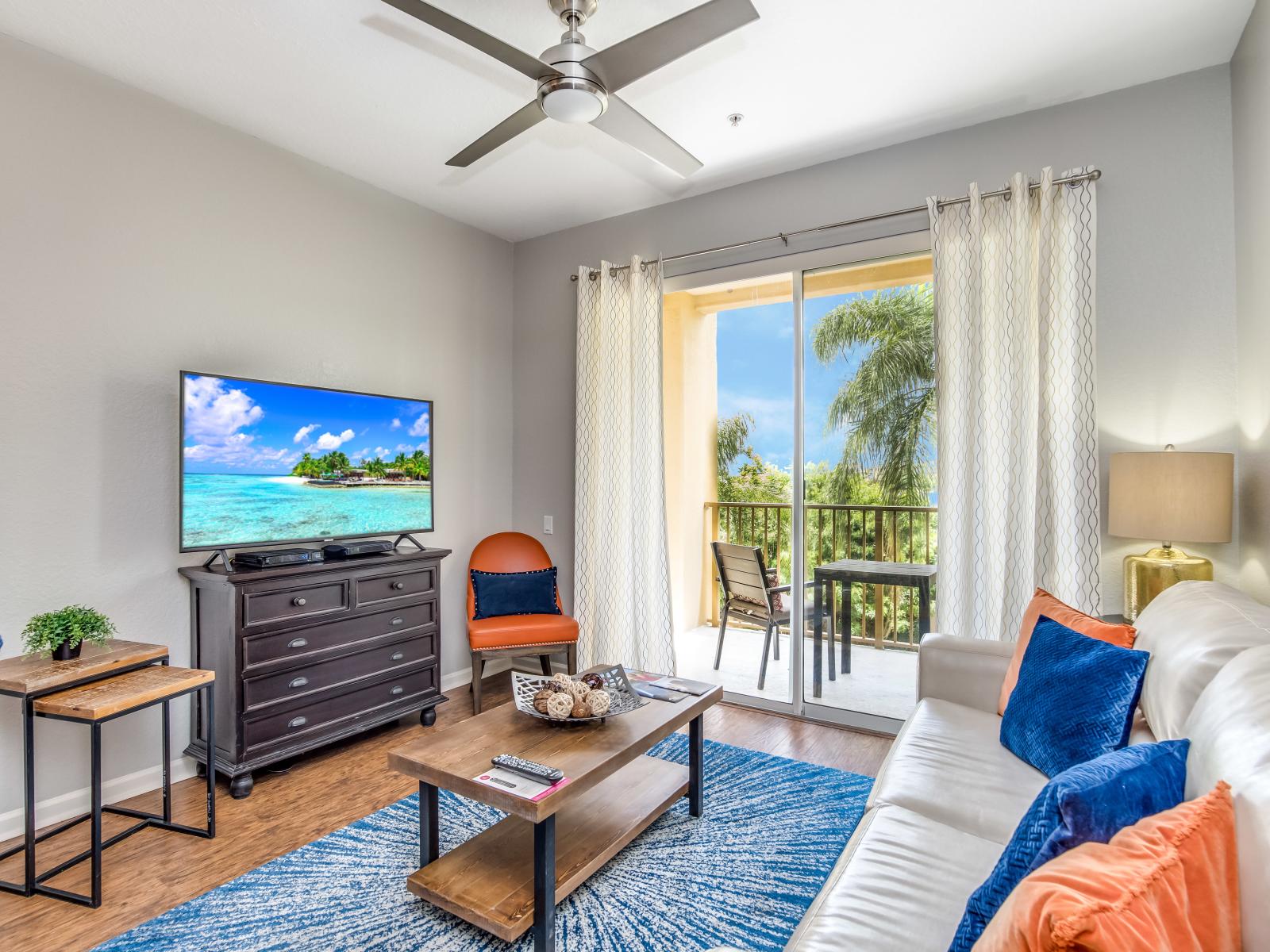 Spectacular living room of the condo in  in Orlando - Magnificent private balcony with mesmerizing lake views - Availability of a 55" TV for entertainment - Offering the perfect blend of relaxation and entertainment with cozy sofas