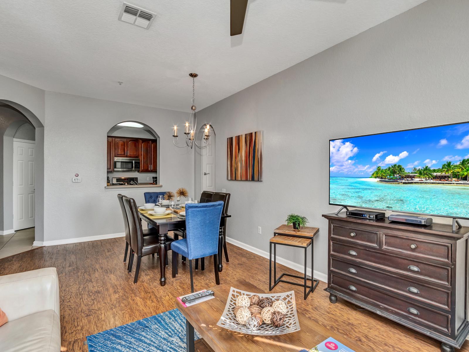 Unwind in the living room sanctuary, complete with a 55" TV and breathtaking views of Lake Cay, offering the perfect blend of relaxation and entertainment.