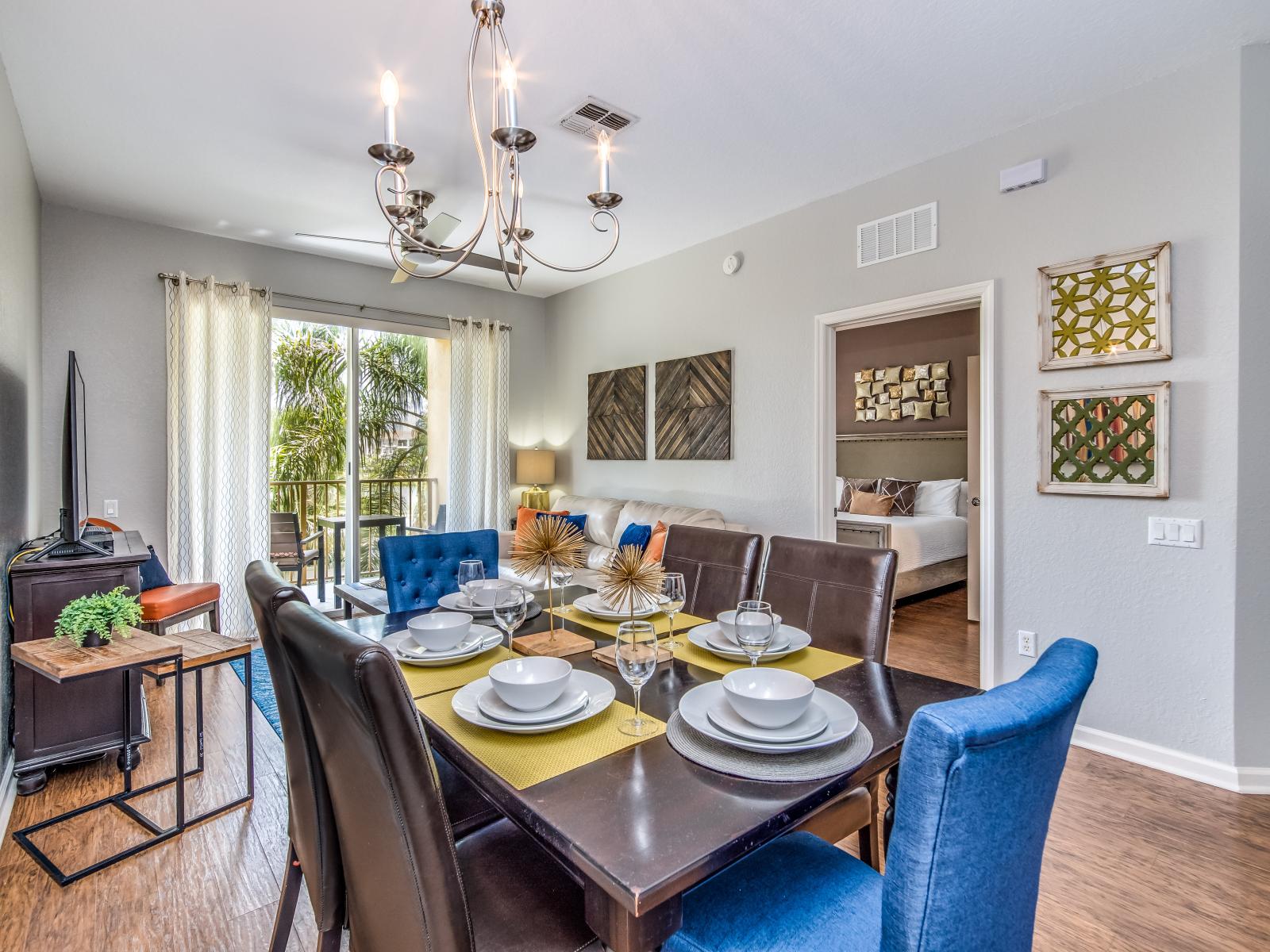 Sublime dinning area of the condo in Orlando - Spacious 6 persons dinning - Gloriously decored with wall paintings and elite chandelier - Connected with living area and balcony -stunningly wooden furnished floor