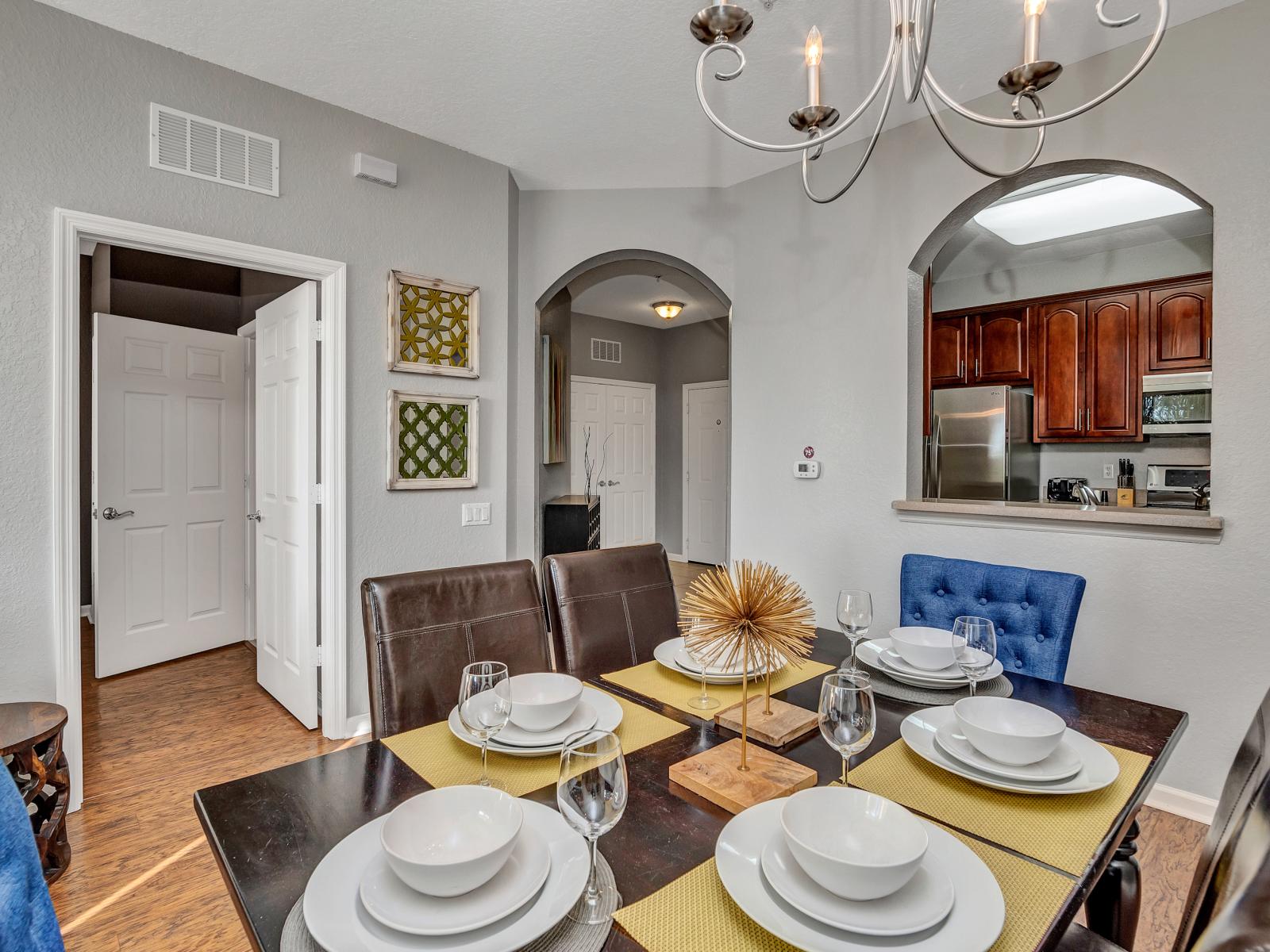 The dining area offers a cozy space for relaxation and shared meals, blending comfort with style. With a beautiful see through window between kitchen and dinning