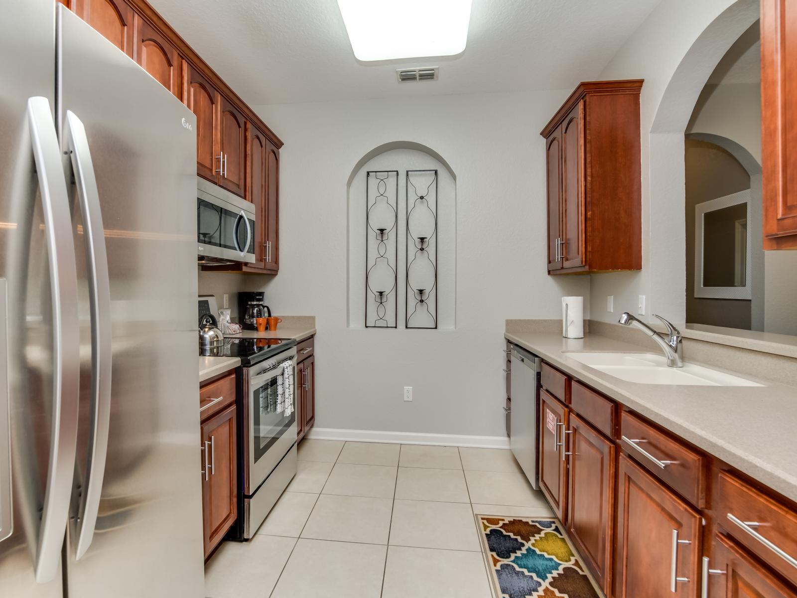 Fully equipped kitchen of the condo in Orlando - Every tool and appliance awaits to bring your recipes to life. - Sufficient space to walk and work with ease - Elegant lighting