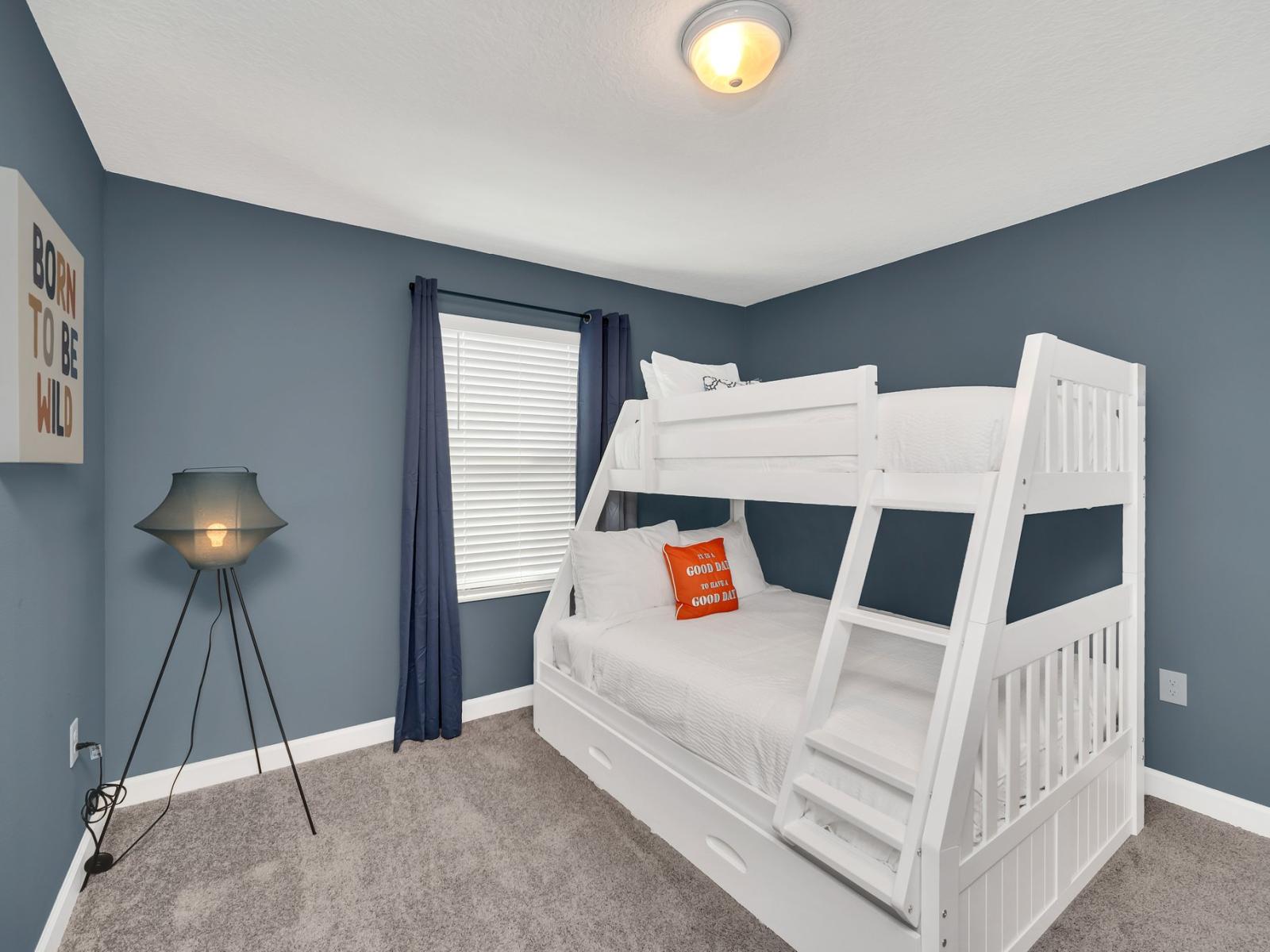 Cozy bedroom of the townhouse in Kissimmee Florida - One double bed and a single bed on the top - Plush bedding and pillows for a luxurious feel - Bedroom with a cozy ambiance, blending comfort and aesthetics