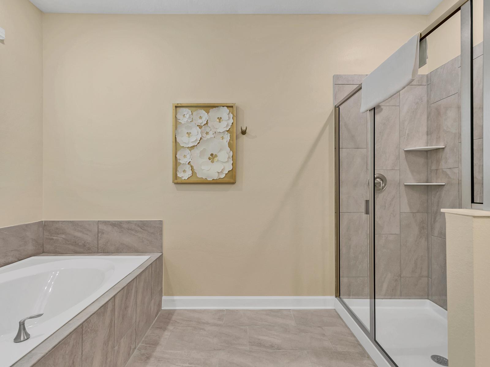 Treat yourself to a luxurious spa experience in our lavish bathroom, complete with a deep soaking tub, walk-in shower area, plush towels, and bath amenities.