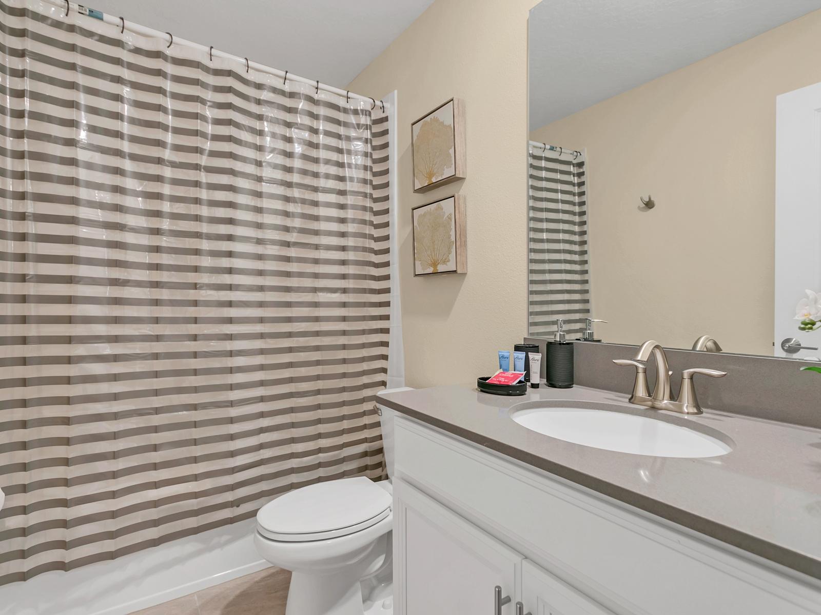 What could be better than a warm, comforting shower in this spotless bathroom with elegant bathtub with overhead shower.