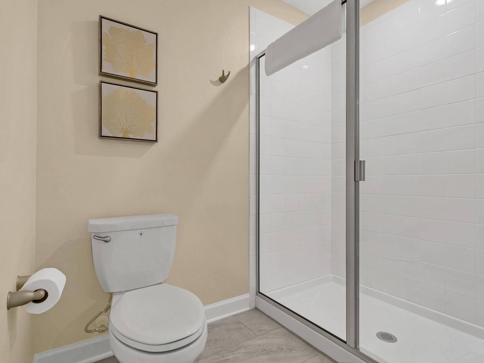 Elegant Oasis": Step into sophistication in our elegant bathroom, featuring tiled walk-in shower area, stylish fixtures, and a spacious layout designed for your comfort and relaxation.