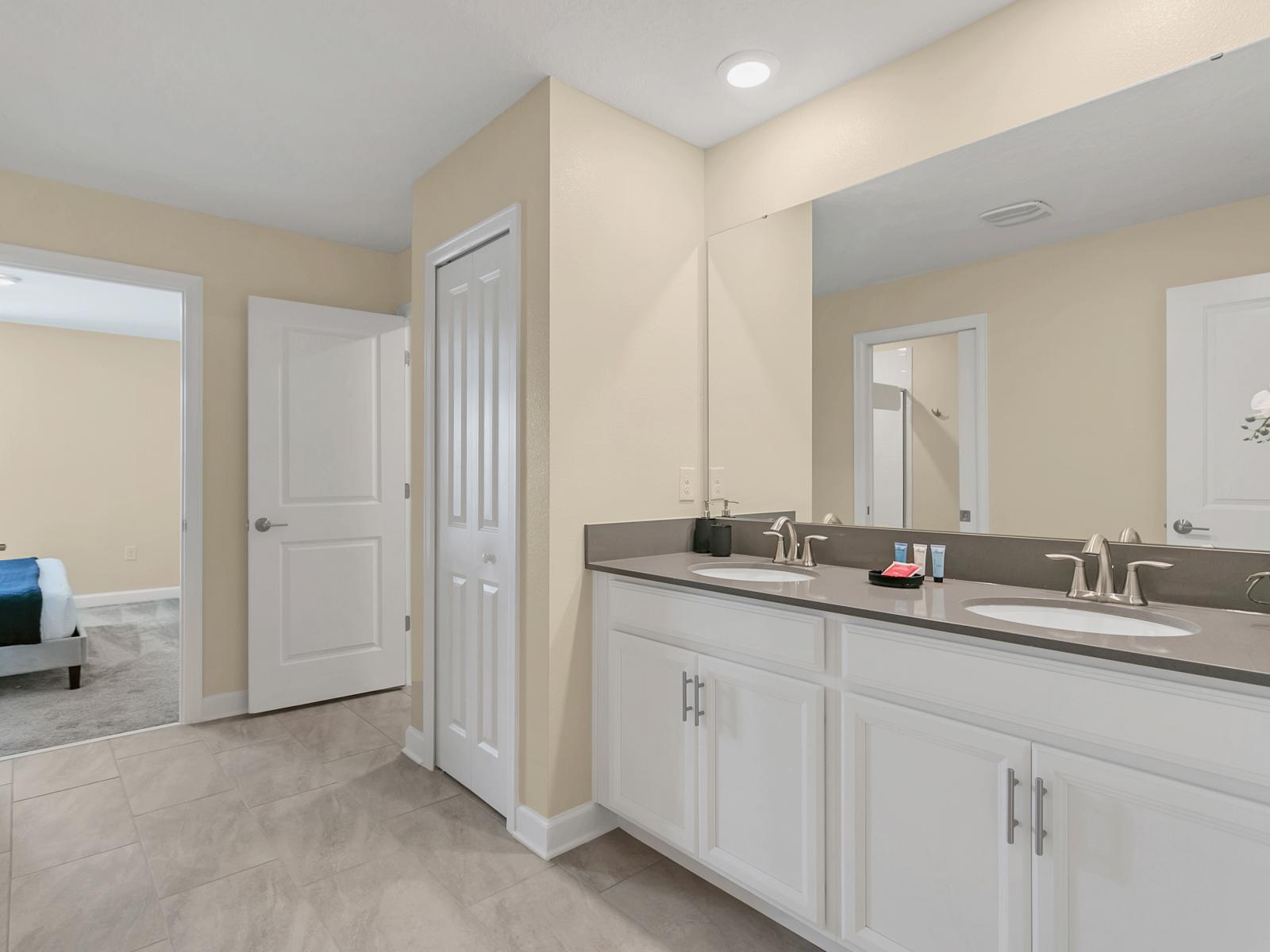 What could be better than a warm, comforting shower in this spotless bathroom with elegant dual vanity, large mirror and upscale lighting.