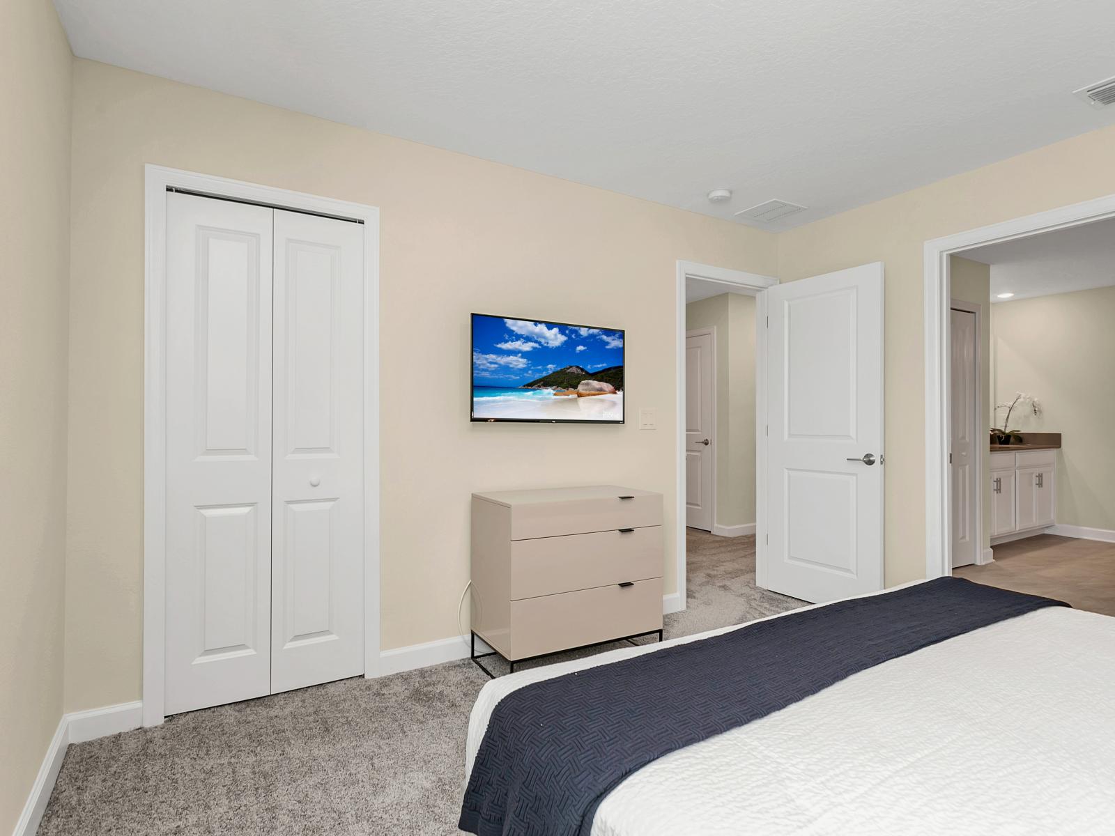 Indulge in Modern Serenity: Step into this inviting Bedroom Retreat adorned with a Chic Gray Accent Wall, where contemporary elegance meets tranquil comfort, offering you a peaceful haven for rest and rejuvenation.