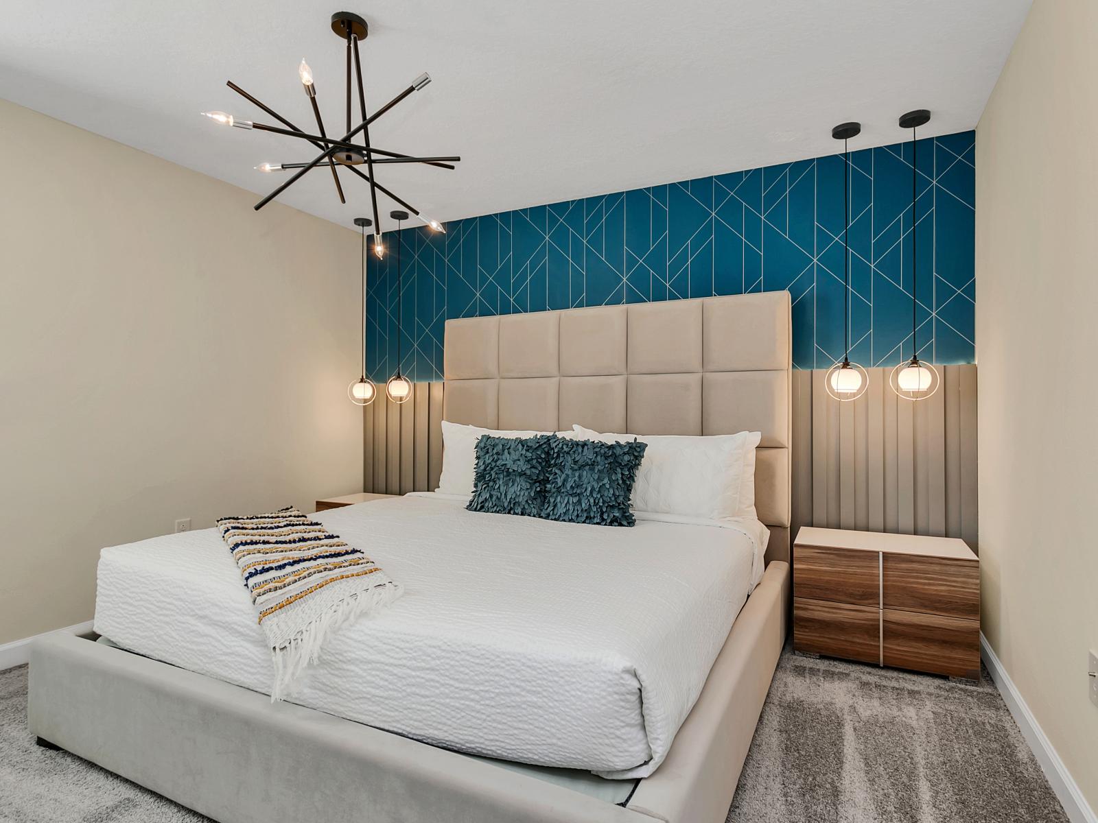 Inviting bedroom of the home in Kissimmee Florida - Intricately designed wall details - Immerse in luxury with chic furnishings, setting the tone for sophistication - Cozy double bed and elegant lighting fixtures