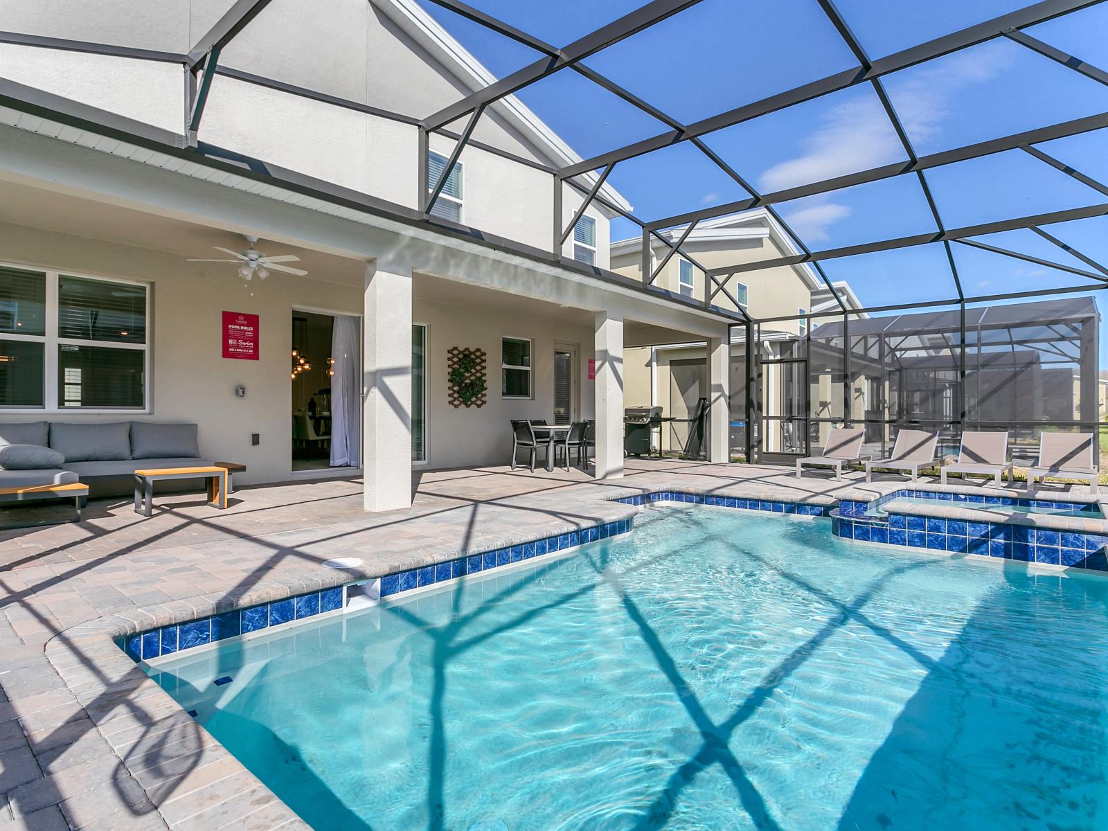 Rejuvenate in your exclusive pool or unwind on the expansive outdoor patio area, ideal for hosting gatherings, complete with a personal splash pool and sufficient outdoor seating.