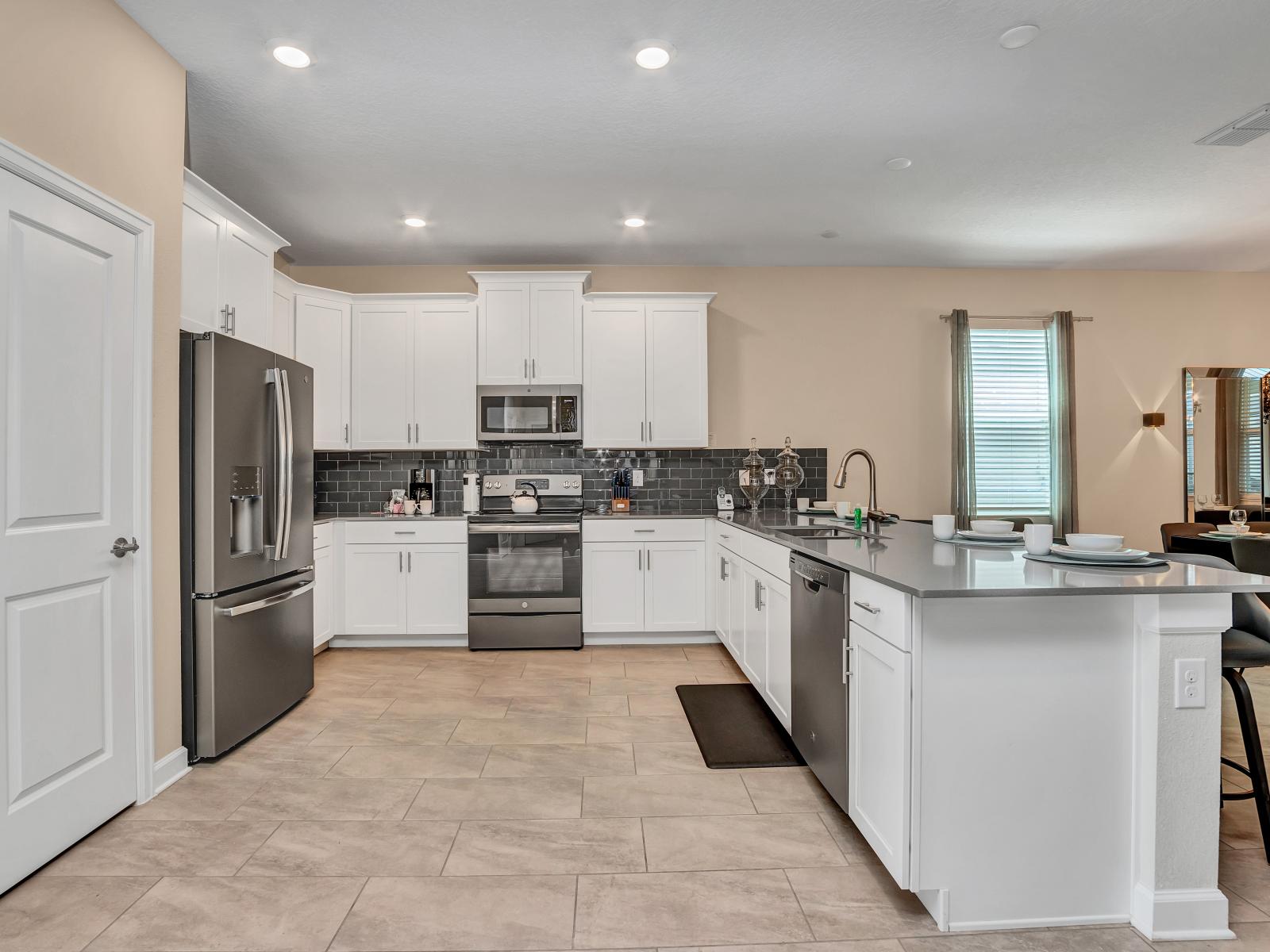 Elegant Kitchen of the Apartment in Florida near Moss Park - Modern kitchen with sleek appliances - Smart use of space with versatile storage solutions - Well-lit space with strategically placed task lighting