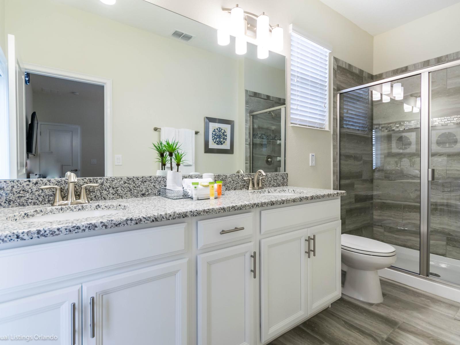 Upmarket Bathroom with dual vanity and glass enclosed shower area