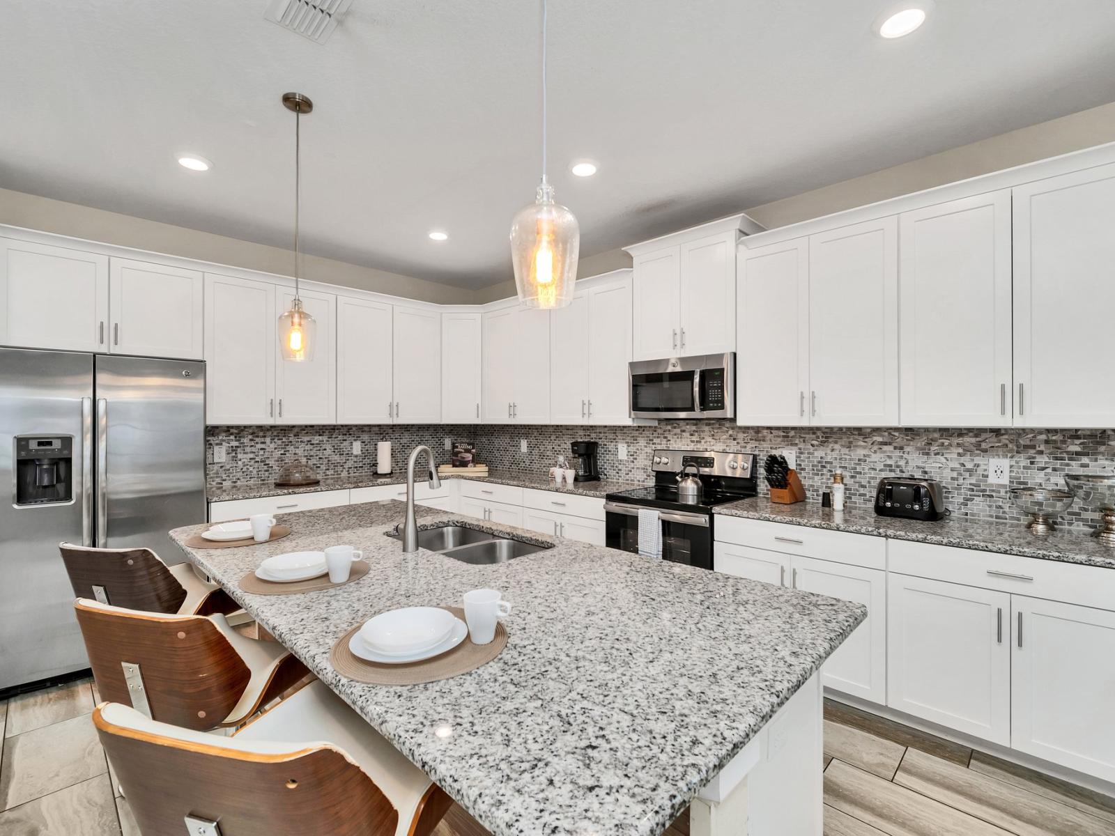 Modern kitchen of the home in Kissimmee Florida - Sleek stainless steel appliances - Contemporary design with clean lines and minimalist aesthetics - Integrated appliances for a seamless and stylish appearance