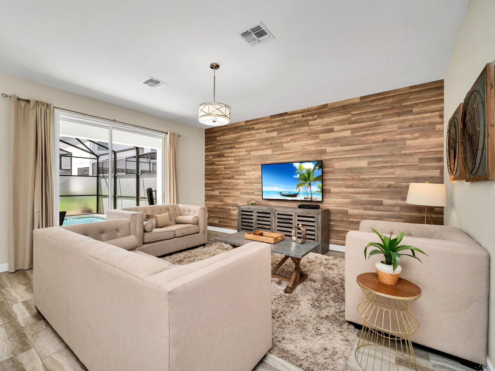 Lofty living area of the home in Kissimmee Florida - Elegantly decorated space with a neutral color palette for a timeless appeal - Thoughtful mix of textures, from plush rugs to tasteful throw pillows - Smart TV and Netflix for entertainment