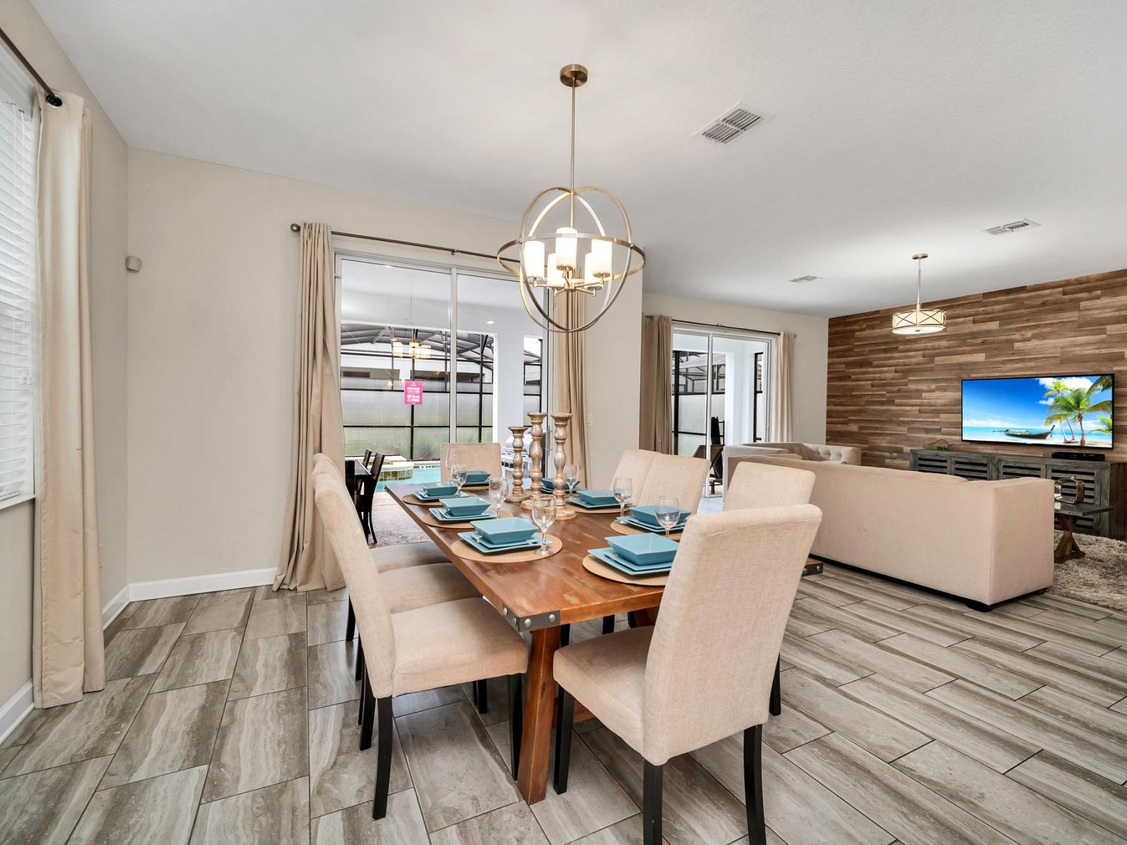 Sleek dining area of the home in Kissimmee Florida - 8 Persons dining - Sophisticated design with a blend of modern and classic elements - Thoughtful lighting fixtures creating an intimate and inviting atmosphere