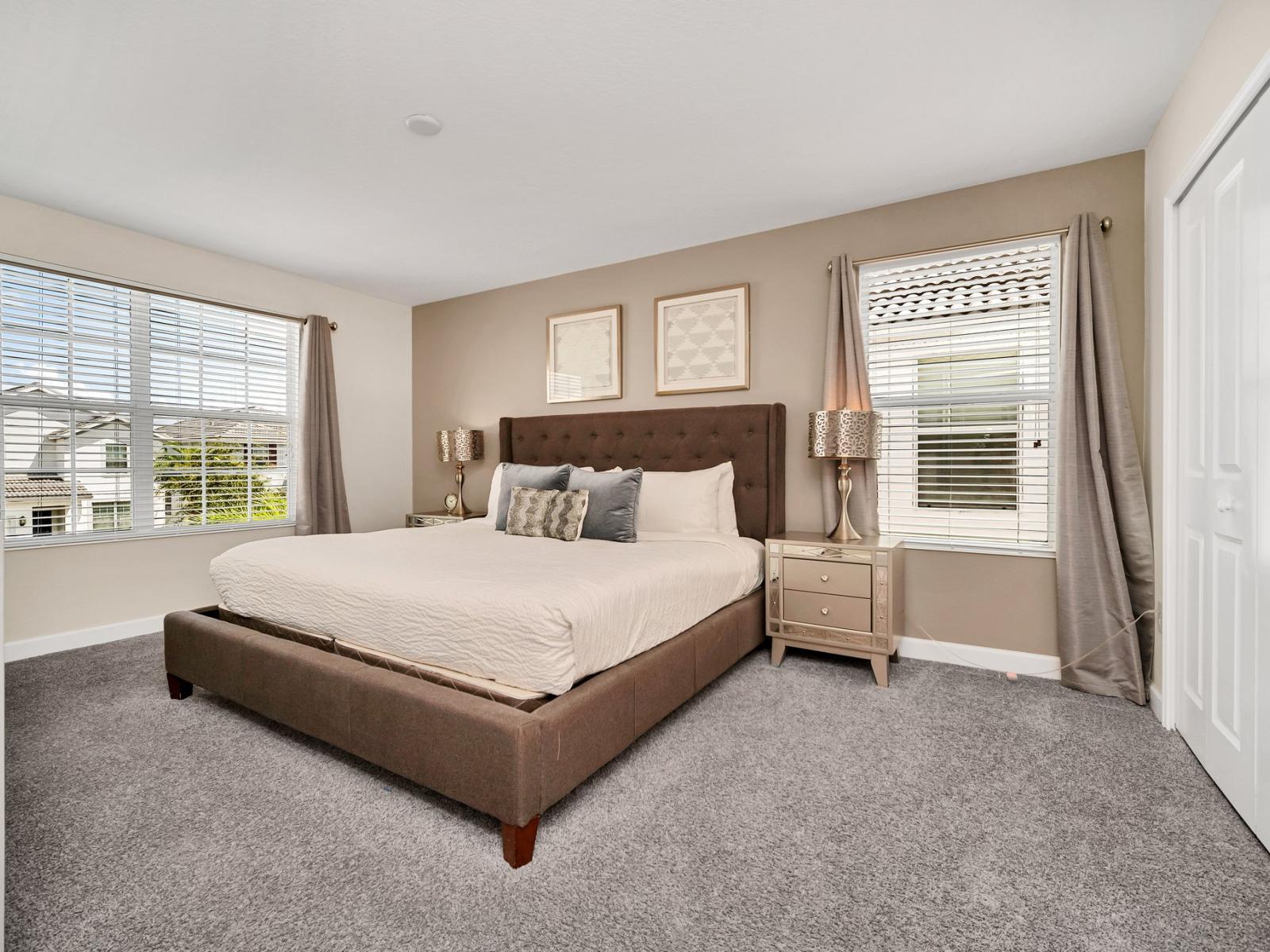 Calming bedroom of the home in Kissimmee Florida - Spacious bedroom offering comfort and style - Cozy retreat with a plush bed, perfect for relaxation - Stunning views from the bedroom window