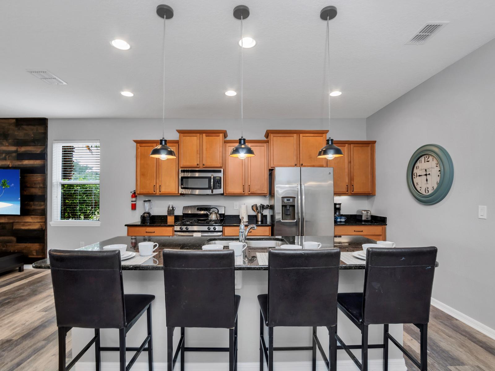 Sleek kitchen of the townhouse in Davenport Florida - Integrated appliances for a seamless and stylish appearance - Open concept connecting the kitchen to the dining and living area - Elegant and coordinated color palette for a cohesive look