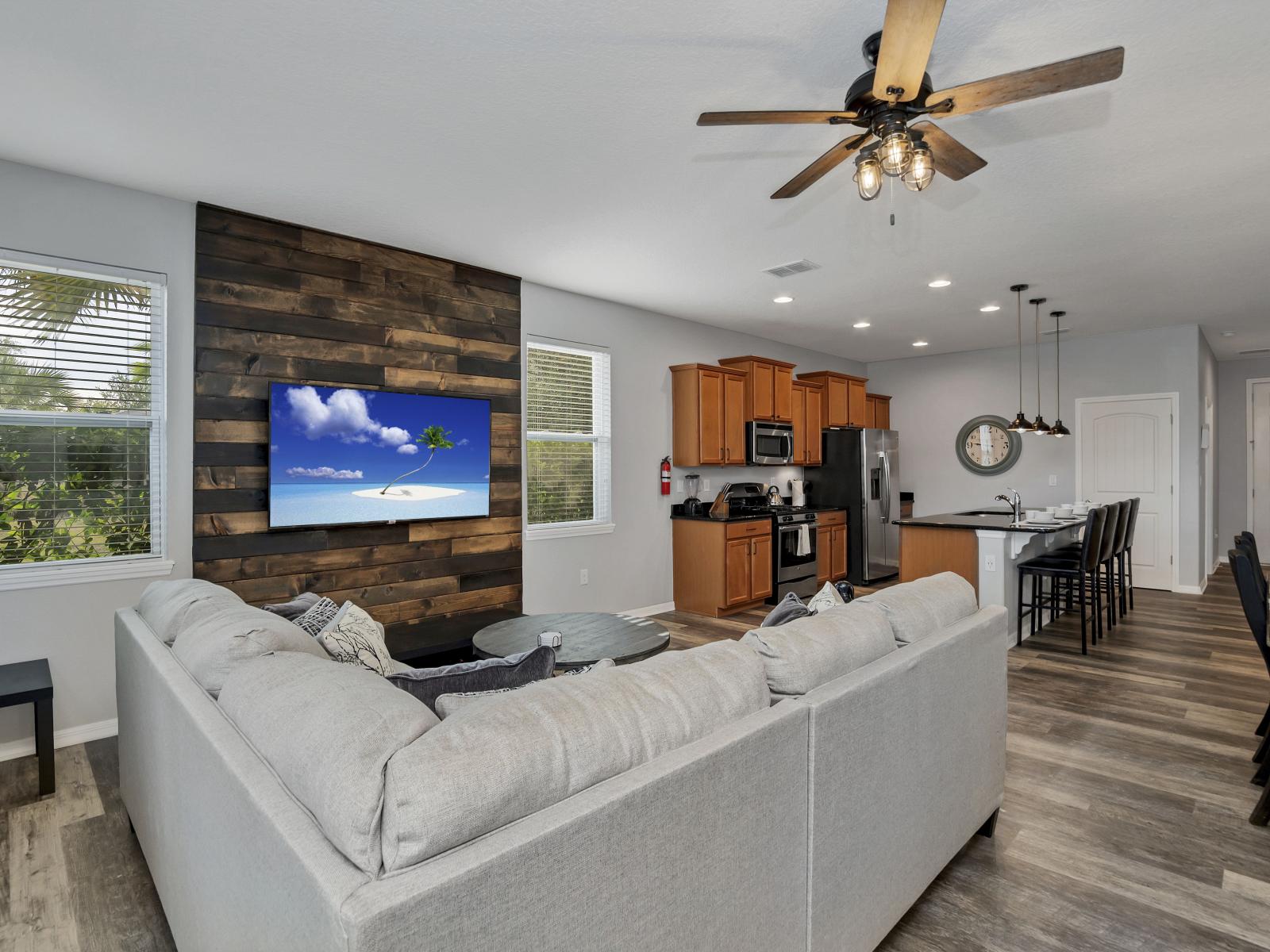 Cozy living area of the townhouse in Davenport Florida - Well-chosen lighting fixtures adding both functionality and charm - Cohesive design aesthetic carried through from furniture to window treatments