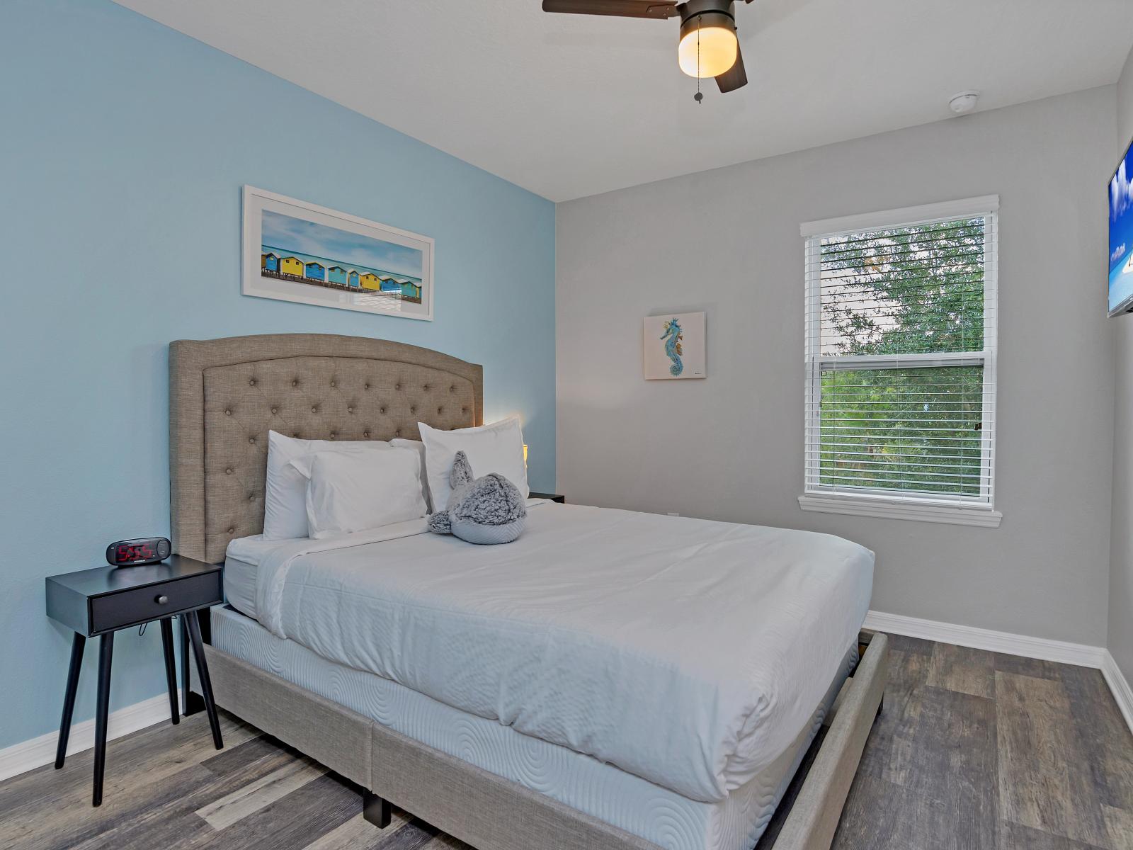 Alluring bedroom of the townhouse in Davenport Florida - Smart TV for entertainment - Minimalist decor, creating a clean and uncluttered sleeping space - Stunning views from the bedroom window