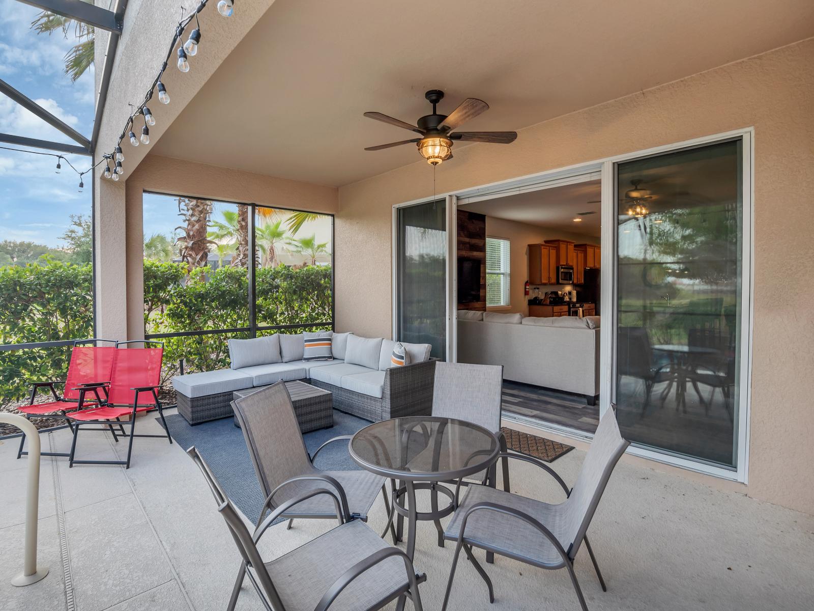 Lush outdoor seating and dining area of the townhouse in Davenport Florida - Dine al fresco, where every meal becomes a breath of fresh air - Extends living space for outdoor enjoyment - Cozy seating area conducive to relaxation and socializing