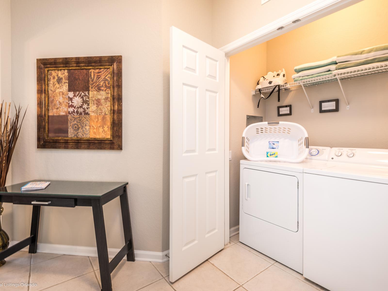 Behold the laundry area equipped with a full-size washer and dryer, offering convenience and efficiency for all your laundry needs.