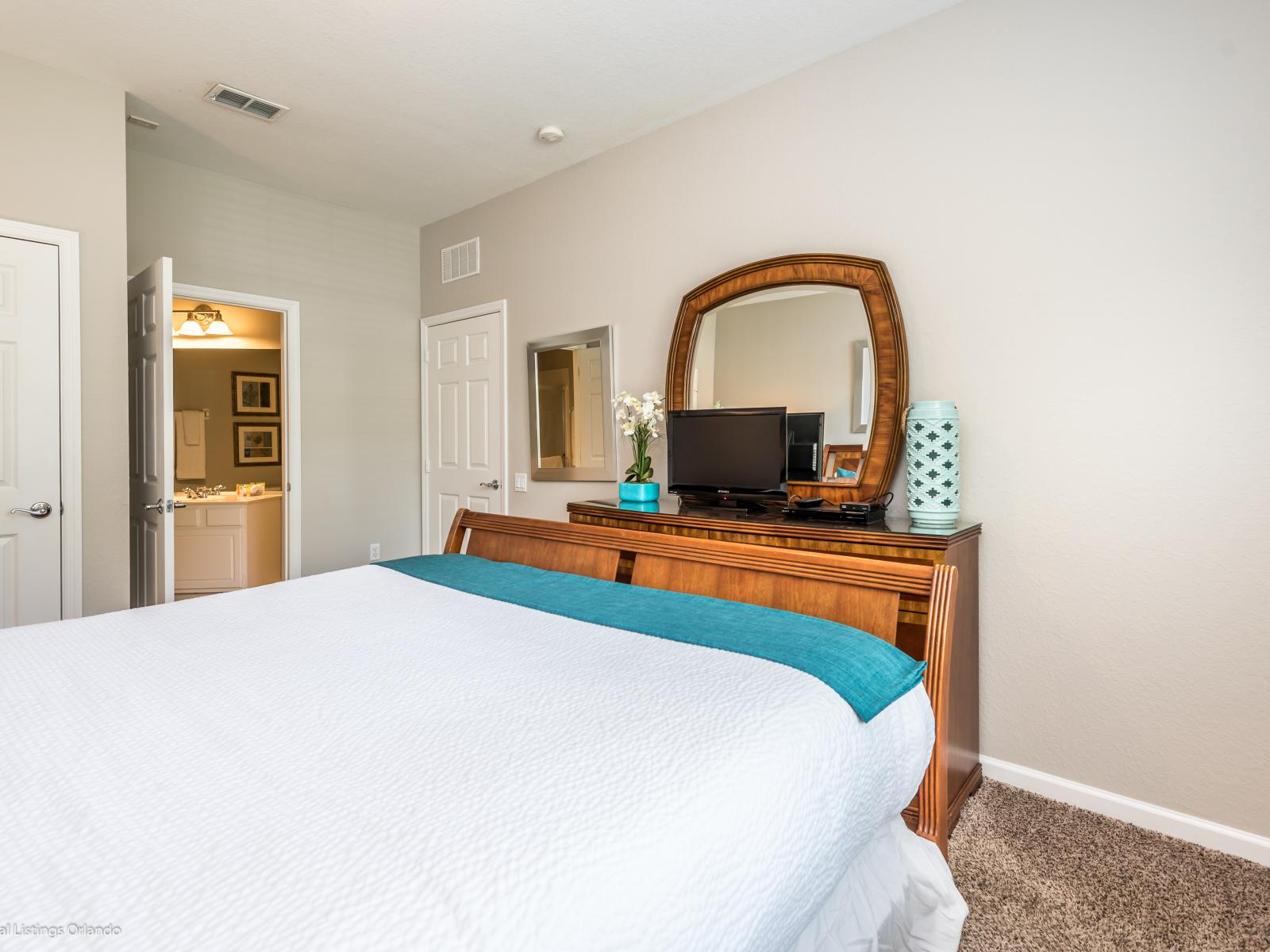 Unwind in luxury and style in this elegantly appointed bedroom. From the plush bedding to the tasteful decor, every detail is thoughtfully curated to create a serene and inviting atmosphere for rest and relaxation.