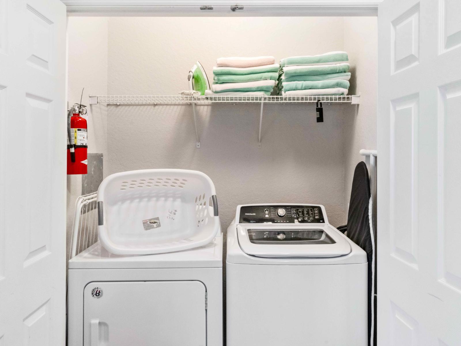 The laundry area boasts a full-size washer and dryer, ensuring that you can easily keep your clothes fresh and clean throughout your stay.