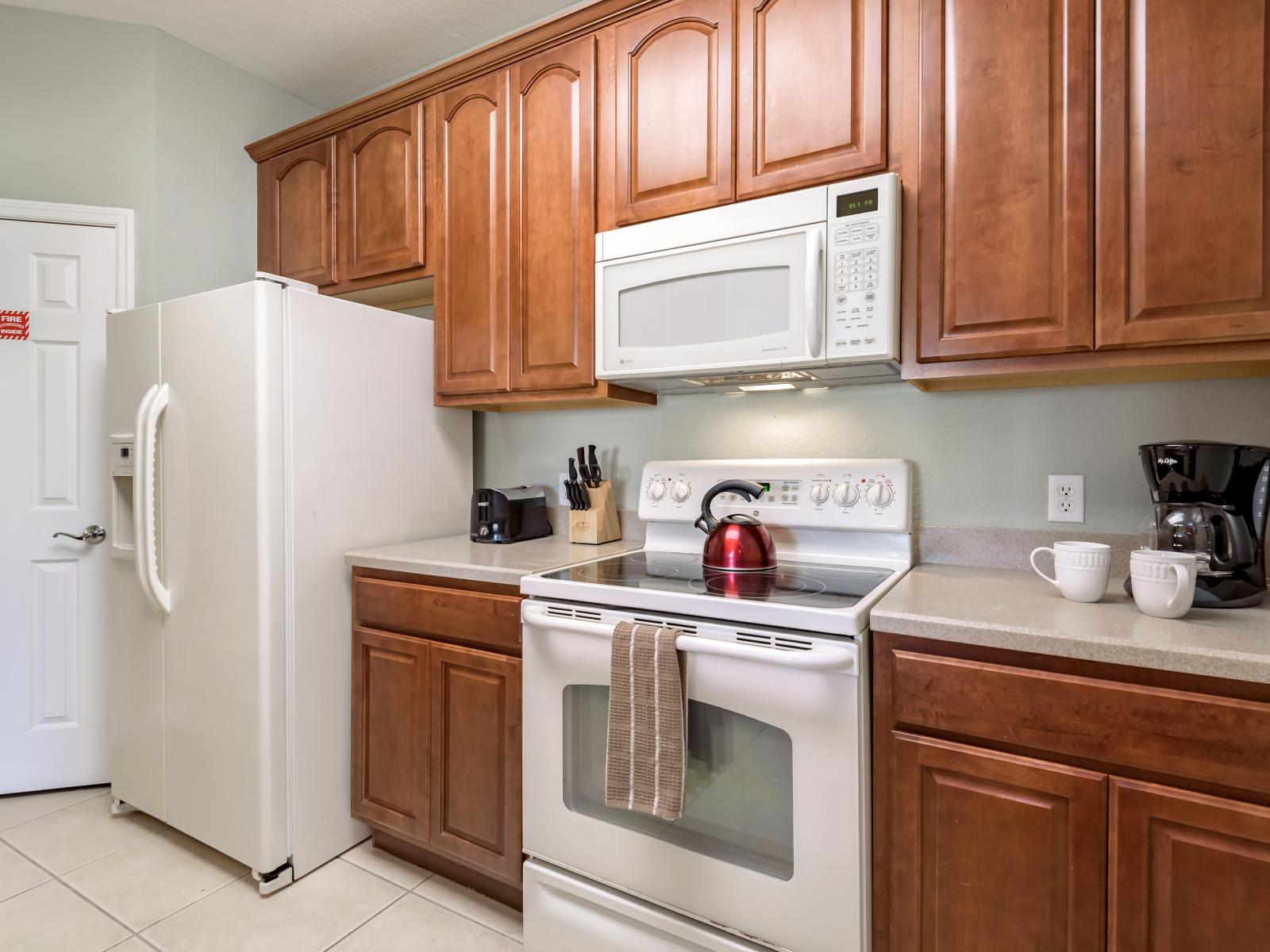 A modest yet fully functional kitchen, offering a finished look and practicality.