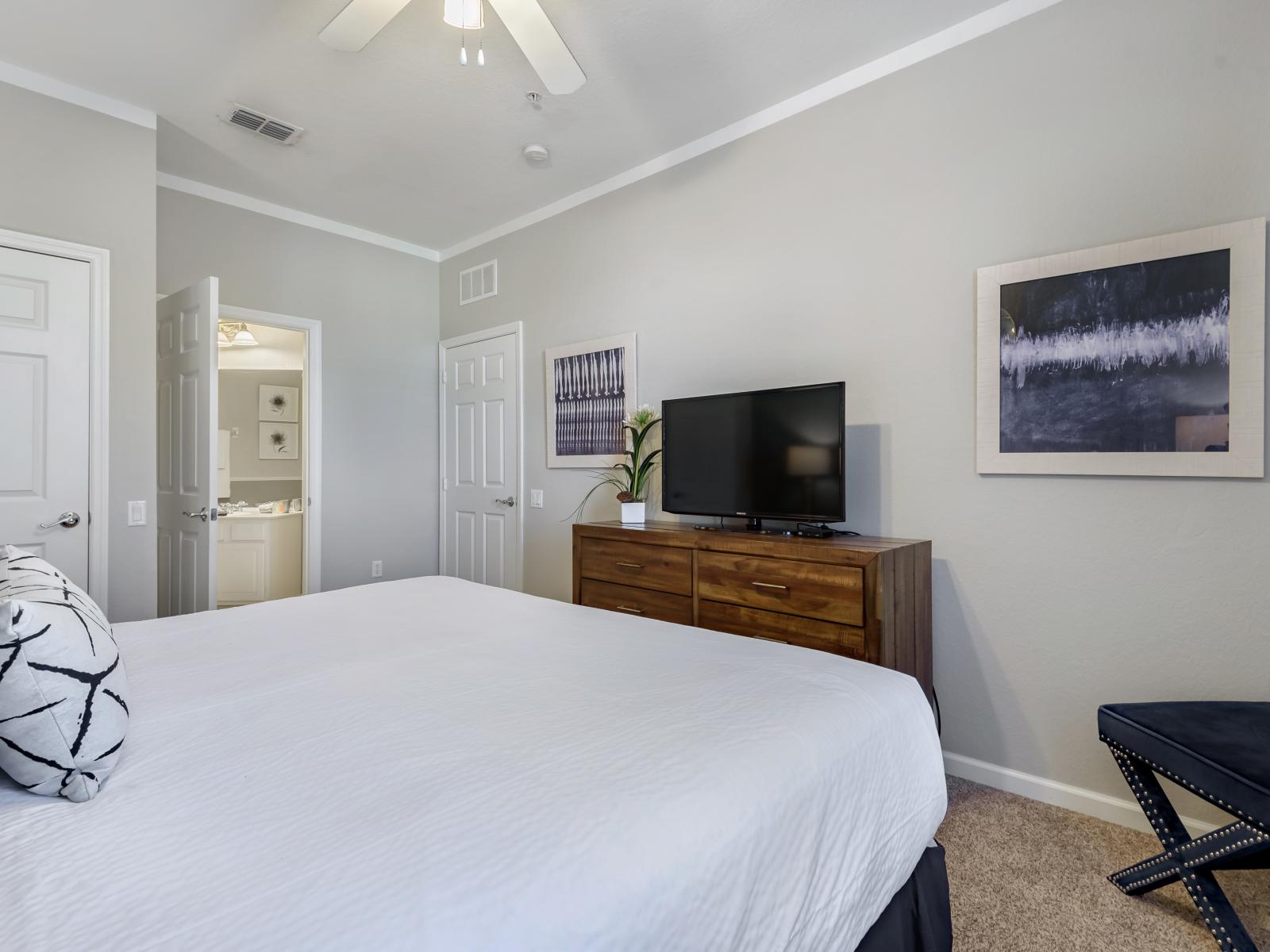 Relax in the master bedroom, featuring a king-sized bed and TV for entertainment, complemented by an ensuite bathroom for added convenience.