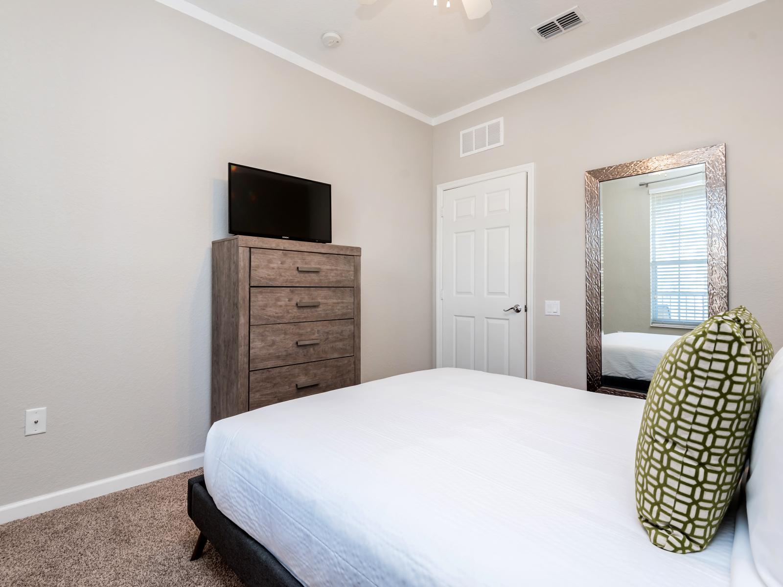 Step into this serene second bedroom, designed for ultimate relaxation and rejuvenation.