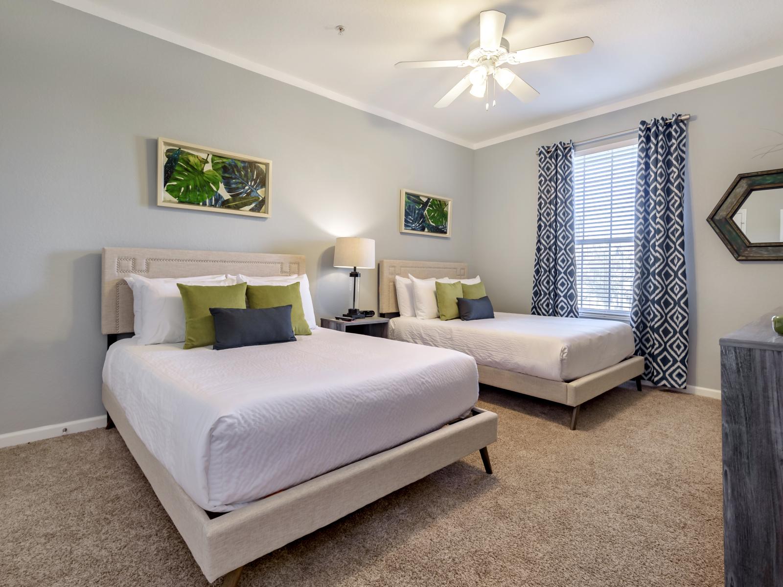 This inviting bedroom features two cozy beds, perfect for a comfortable night's sleep or sharing with a friend or family member.