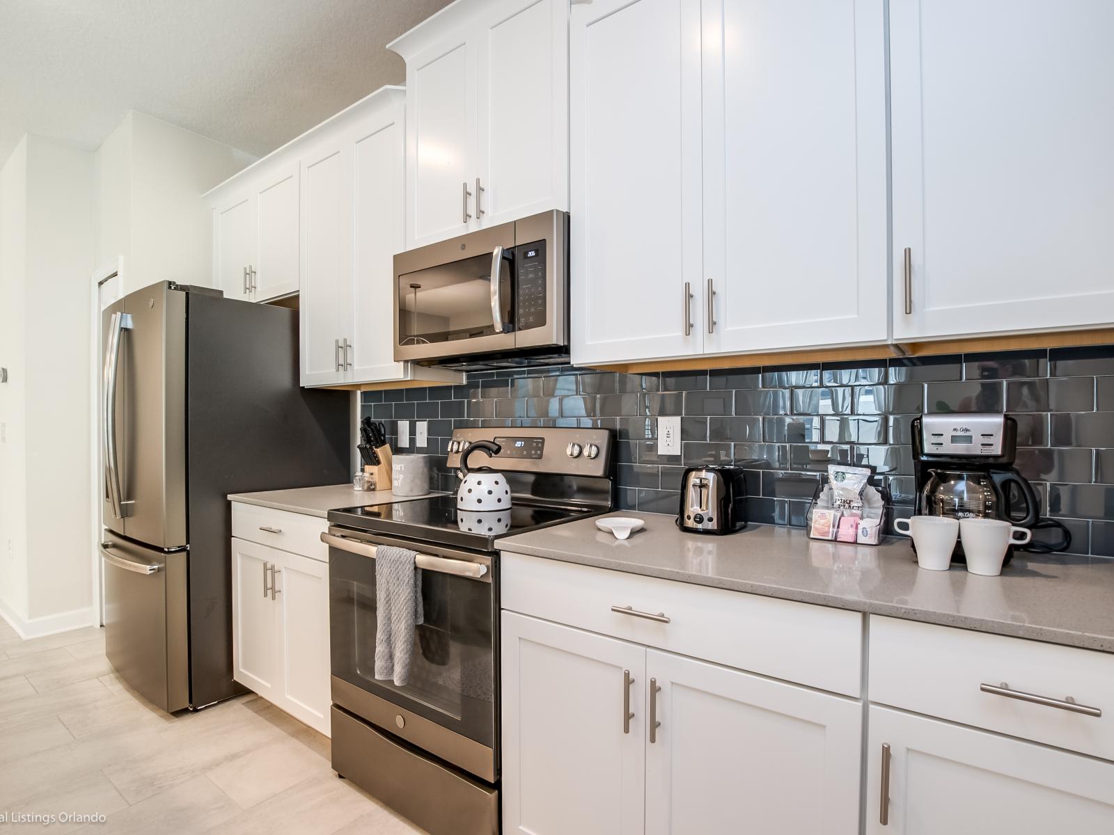 Modern kitchen of the townhouse in Kissimmee Florida - Stainless Steel Appliances - Availability of all kitchen accessories - Enjoy the Convenience of a Fully Equipped Kitchen - Sufficient space to walk and work according to your ease