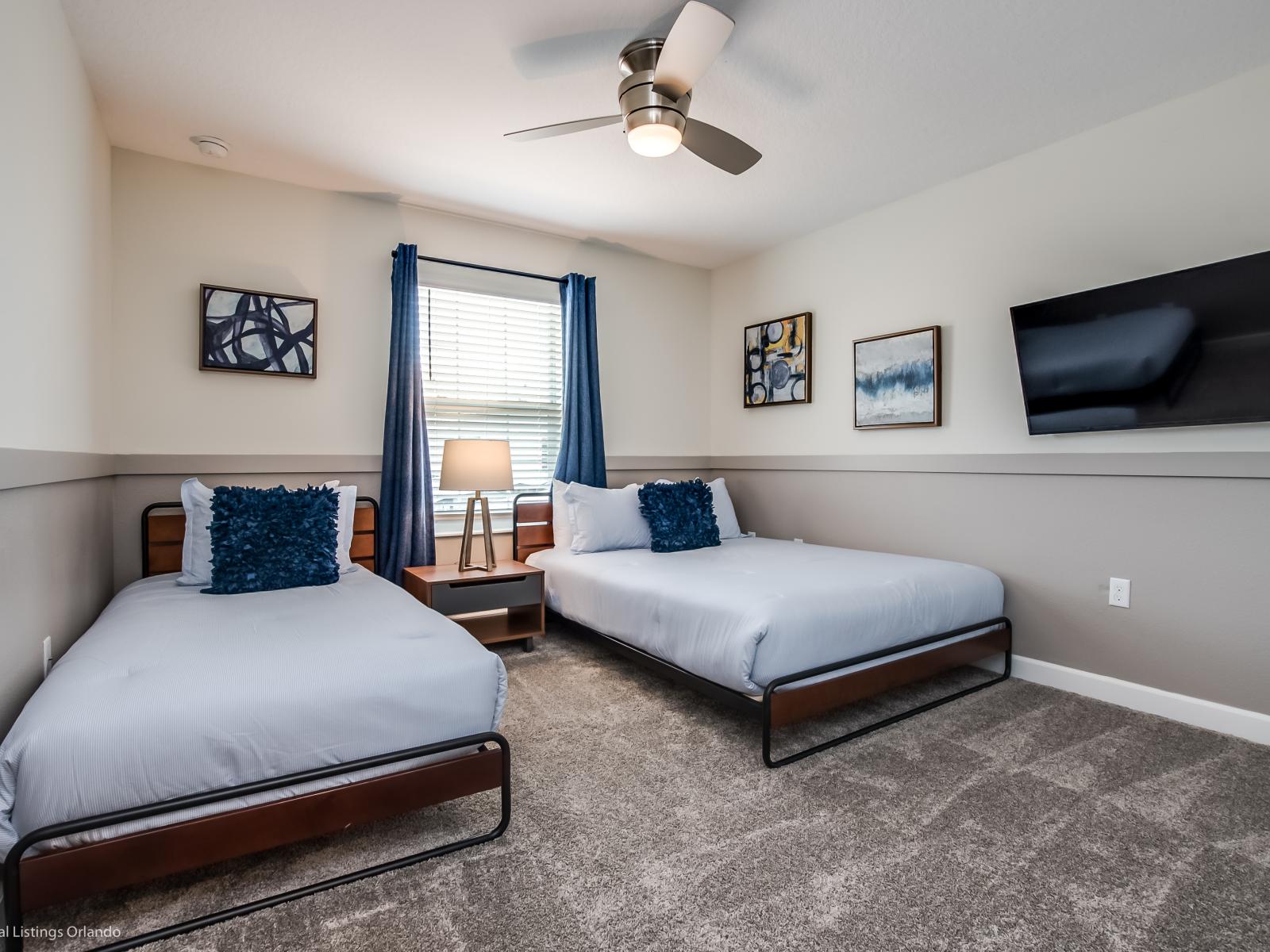 Spacious bedroom of the townhouse in Kissimmee Florida - Features two comfortable beds and smart TV, perfect for relaxing - Plenty of sleeping space and cozy bedding, this room offers a restful retreat for a peaceful night's sleep