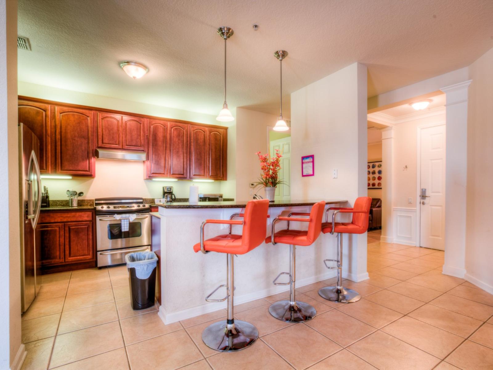 The kitchen is thoughtfully designed with modern appliances and ample counter space, perfect for cooking up culinary delights. Conveniently located in front of the countertop table and high chairs, it's ideal for quick bites or casual dining.