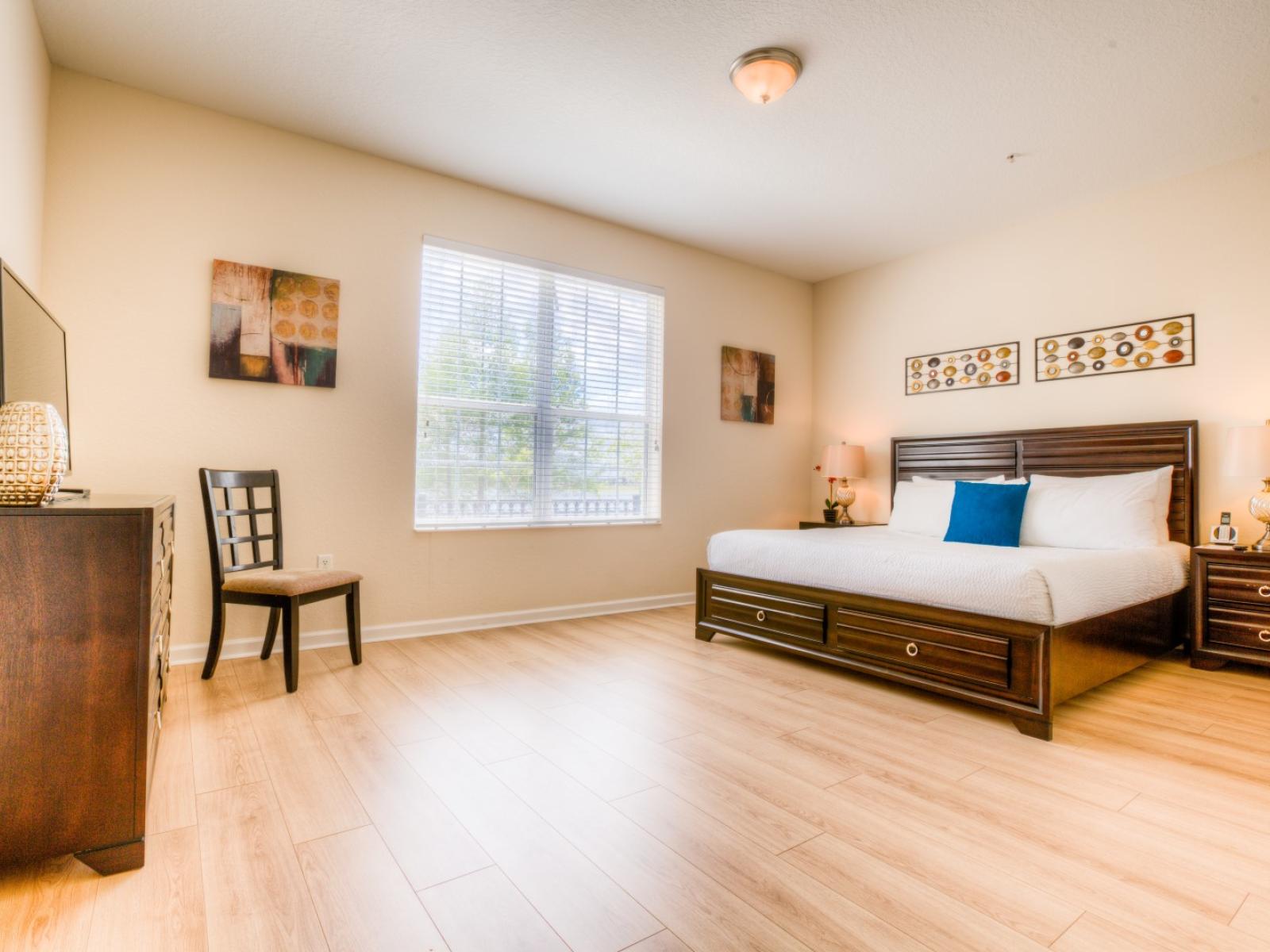 Unwind in luxury in this spacious main bedroom featuring a king-sized bed and a private en-suite bathroom.