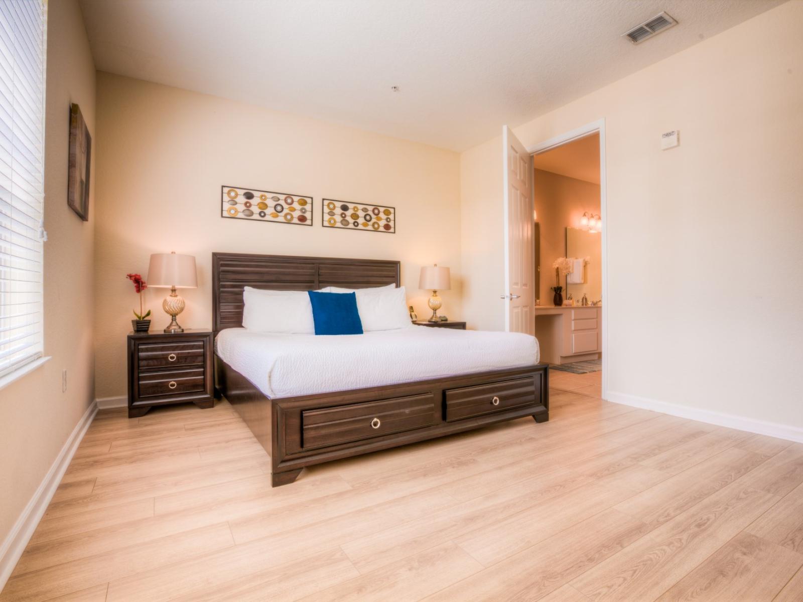 Unwind in the spacious main bedroom featuring a plush king-size bed and a private en-suite bathroom, offering a serene escape after a long day of adventure.