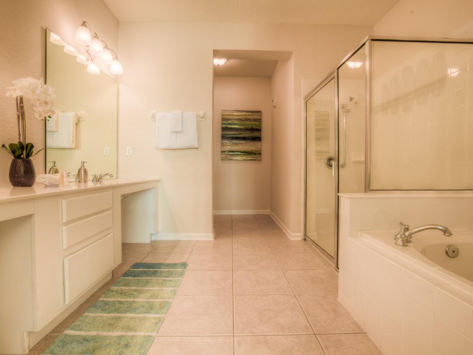 Indulge in the ultimate relaxation with the main bathroom's lavish amenities, including a luxurious bathtub and a convenient walk-in shower.